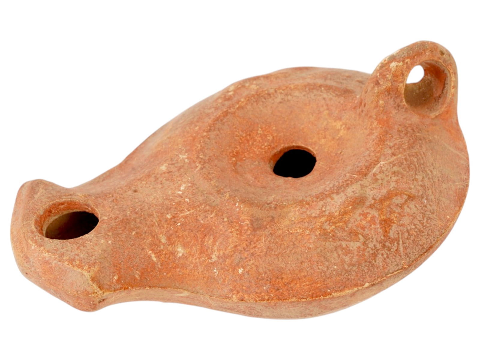 ANCIENT ROMAN TERRACOTTA OIL LAMP 100 TO 300 AD: An ancient Roman painted terracotta pottery oil lamp. The body of the lamp is adorned with engraved ornaments on the shoulders. The lamp is decorated with a raised circle nozzle top and a raised handl