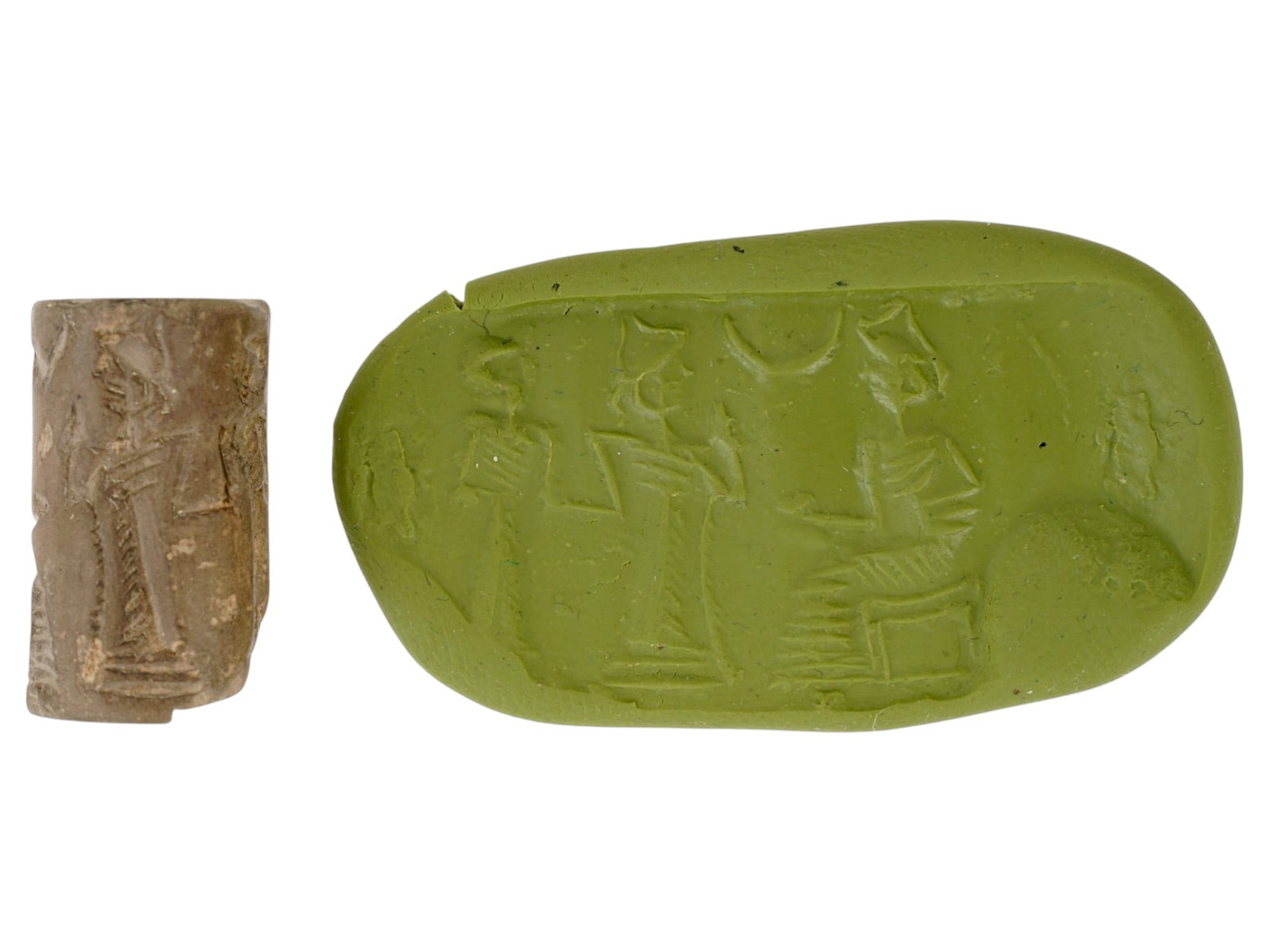 ANCIENT NEAR EASTERN CARVED HEMATITE BEAD CYLINDER SEAL: An ancient Near Eastern hand carved Hematite stone cylinder seal bead. The impression depicts a ritual scene featuring the composition with figures. Cylinder seals were widely used in the ancient Near