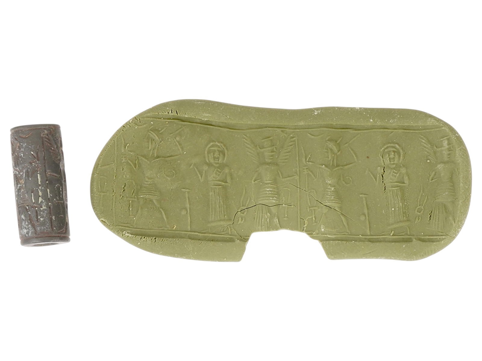 ANCIENT NEAR EASTERN CARVED HEMATITE BEAD CYLINDER SEAL: An ancient Near Eastern hand carved Hematite stone cylinder seal bead. The impression depicts a ritual scene featuring the composition with figures. Cylinder seals were widely used in the ancient Near