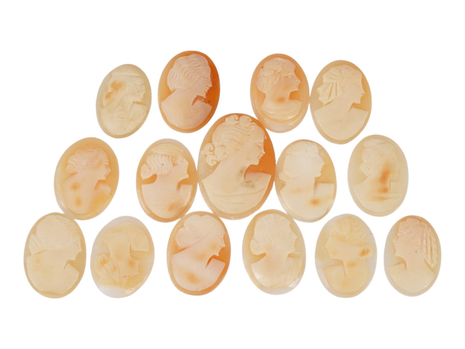 COLLECTION OF CARVED SHELL CAMEOS WITH FEMALE PORTRAITS: A collection of q5 carved shell cameos featuring high-relief female portraits, executed in a traditional classical style associated with Victorian-era jewelry. The loose unmounted pieces display detai