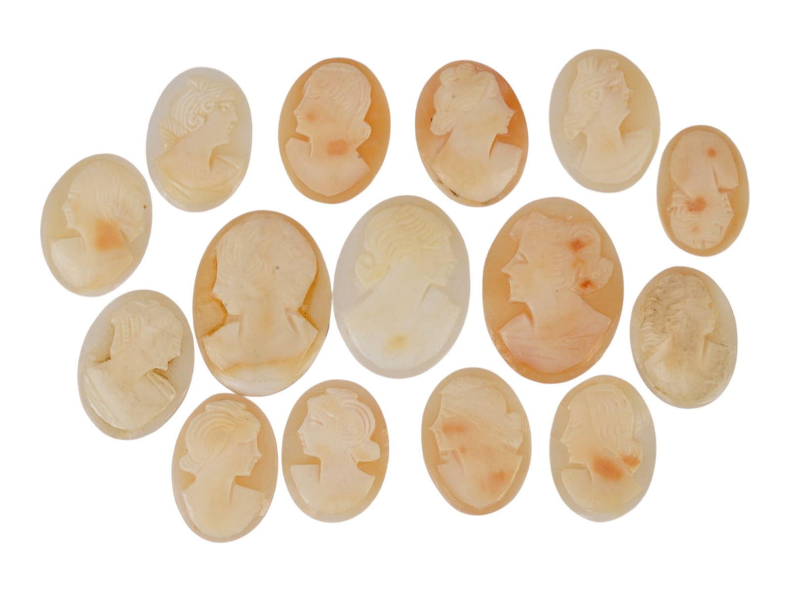 COLLECTION OF CARVED FEMALE PORTRAIT SHELL CAMEOS: A collection of hand carved shell cameos. A total of 15 items. Each piece depicts a female profile portrait rendered in high relief in the Victorian and Roman manners. Each cameo is fashioned in a dis