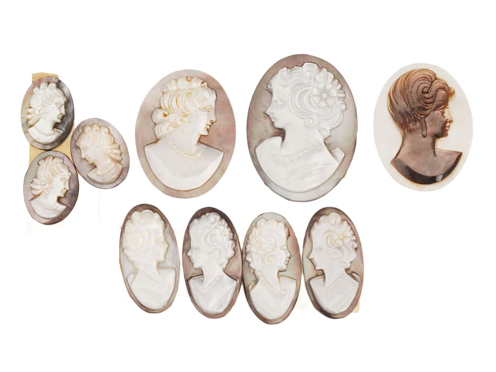 COLLECTION OF 10 CARVED SHELL CAMEO MEDALLIONS: A collection of 10 assorted vintage cameo medallions in various sizes. Each oval cut shell cameo depicts a relief female portrait in profile in the Victorian manner. Vintage Jewelry and Accessories, I