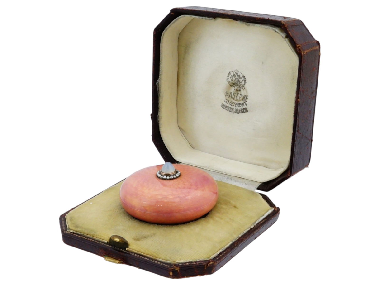 RUSSIAN SILVER ENAMEL TABLE BELL WITH MOONSTONE FINIAL: A Russian silver and enamel table bell. Features a pink guilloche enamel body, topped with a cabochon moonstone finial encircled by seed pearls. Additional decorative elements include a feather motif.