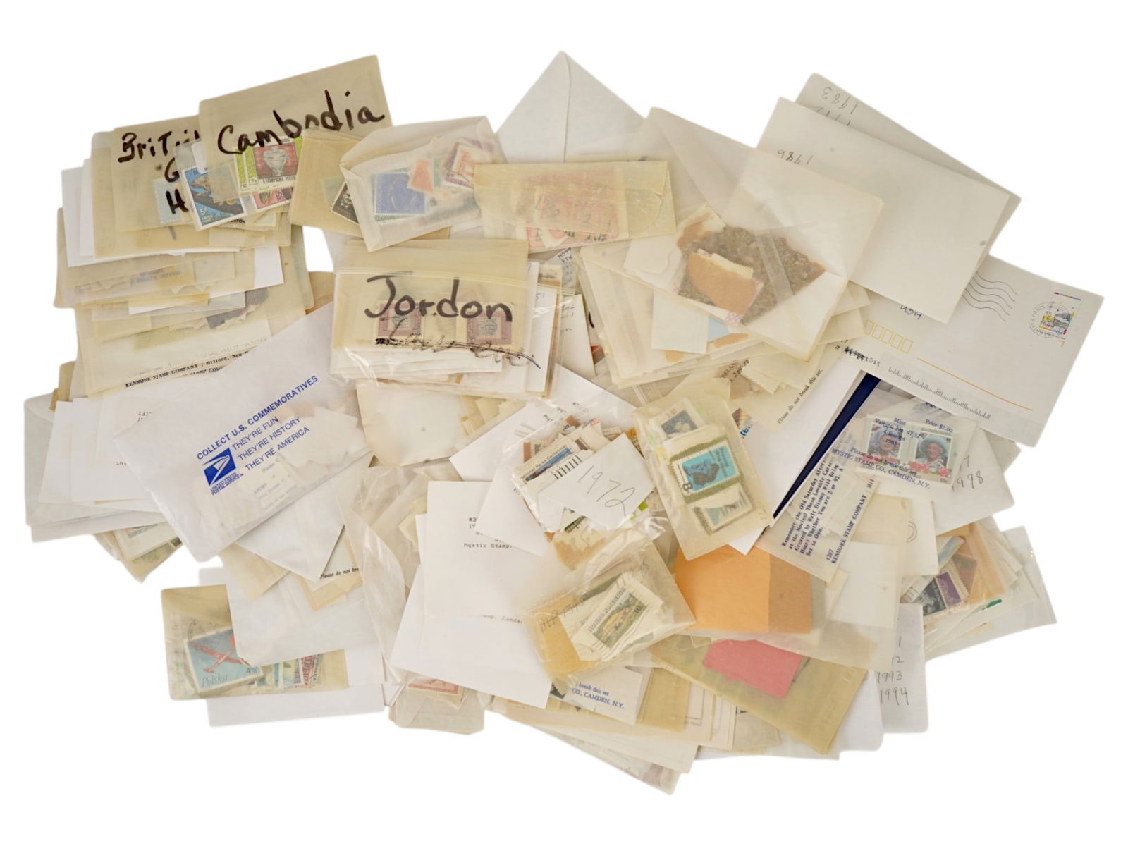 COLLECTION OF ASSORTED VINTAGE POSTAGE STAMPS: A collection of assorted vintage postage stamps from various countries and periods. The group includes a mixture of designs, themes, and denominations, offering a diverse selection for collectors and