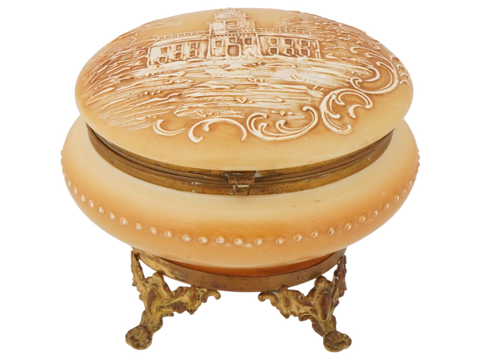 ANTIQUE MOSER STYLE PAINTED GLASS VANITY BOX: An antique late 19th-century Bohemian glass footed jar or trinket box. Moser style. Flattened round shape, hinged lid, beige body color, hand-painted architectural motif on the cover. Brass fittings.