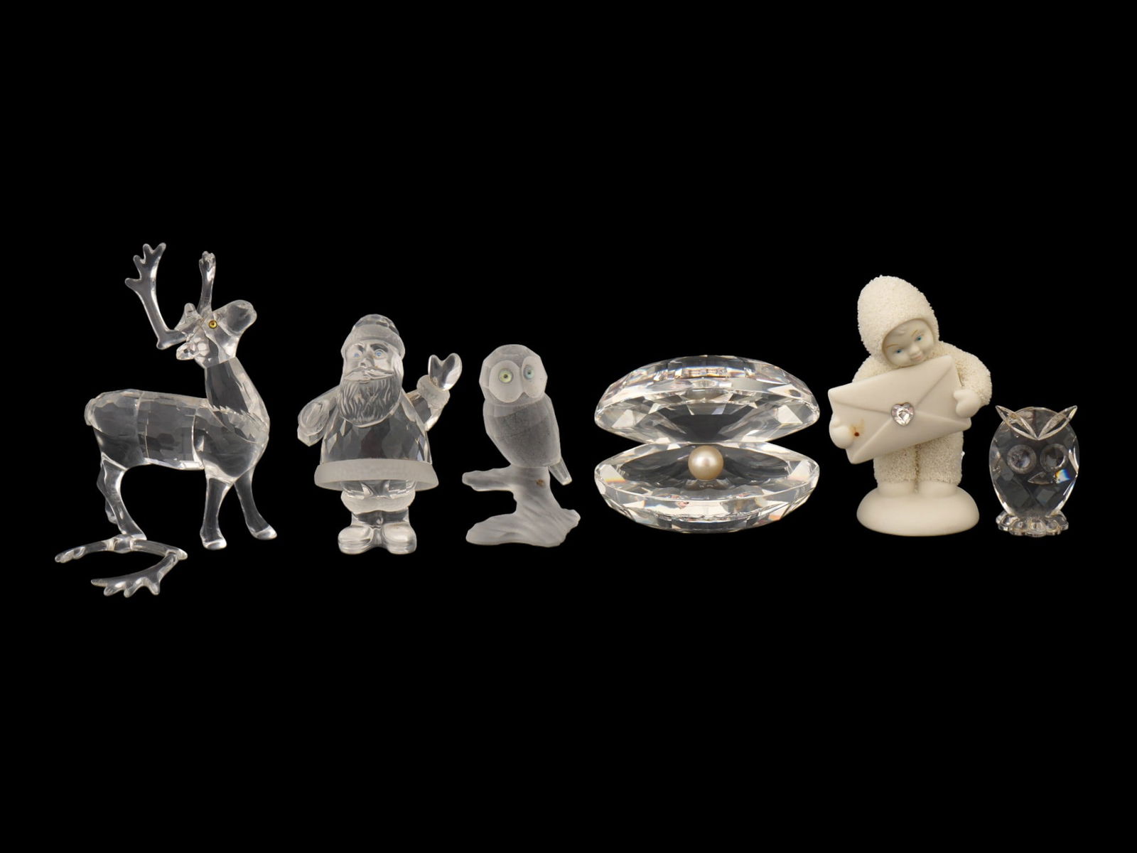 SWAROVSKI CRYSTAL FIGURINES W DEPT 56 SNOWBABIES: A group of four Swarovski faceted crystal figurines and one Department 56 Snowbabies figurine with envelope. It includes a reindeer figurine, Santa Claus, a frosted crystal owl, clam with pearl, and m