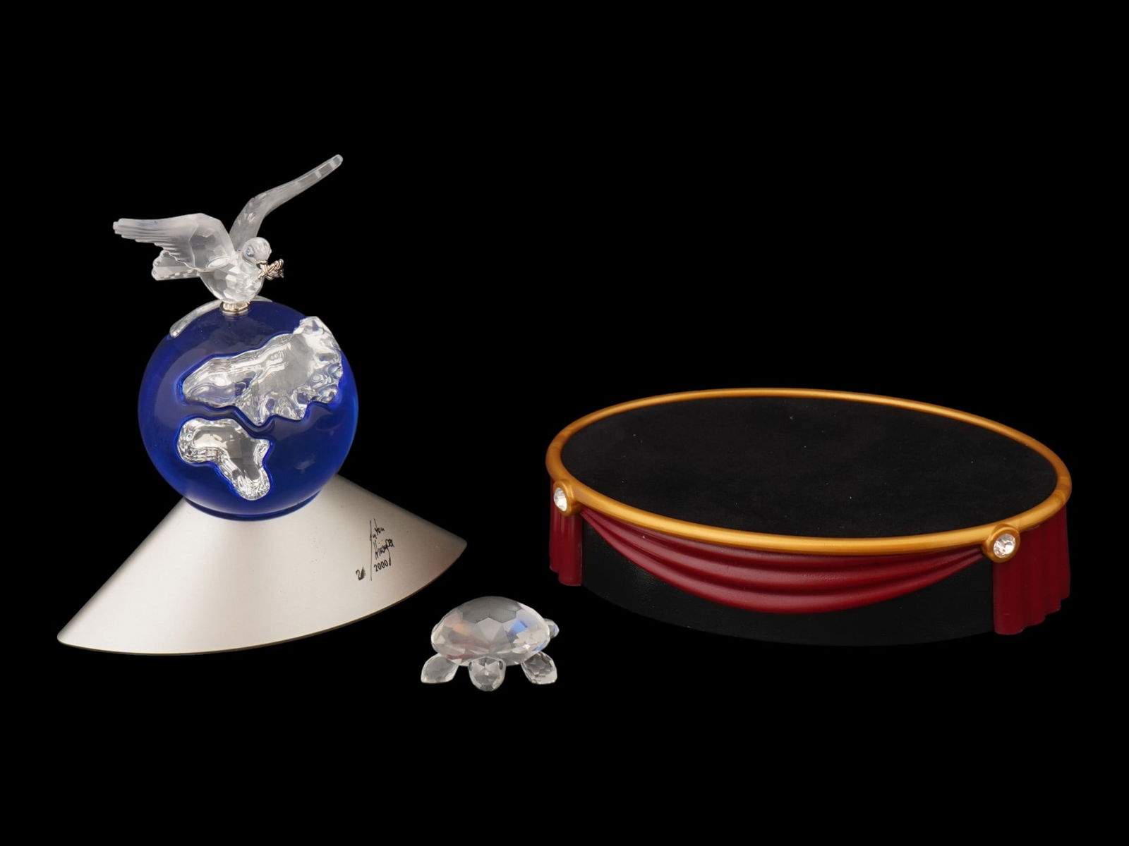 SWAROVSKI 2000 CRYSTAL PLANET TURTLE FIGURINE AND BASE: A group of pieces from the Swarovski 2000 Crystal Planet Millennium Edition set, designed by Anton Hirzinger and released exclusively in the year 2000 to commemorate the new millennium. The centerpiec