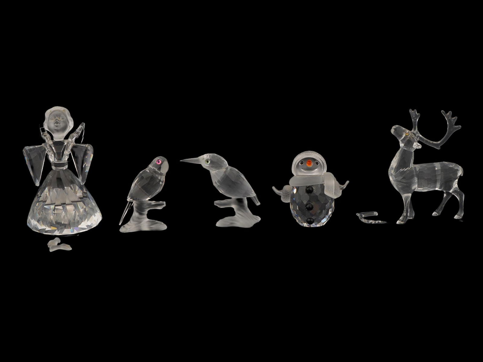 FIVE SWAROVSKI SILVER CRYSTAL FIGURINES: A collection of five Swarovski Silver Crystal figurines. The lot includes figurines of animals, birds, a snowman and an angel. All figurines are presented in branded boxes. Modernist and Contemporary