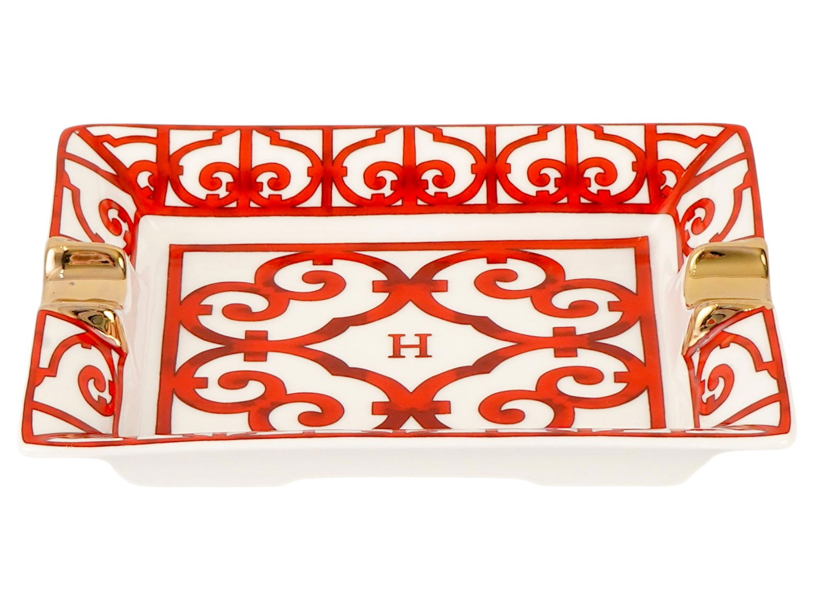 HERMES PARIS BALCON DU GUADALQUIVIR PORCELAIN ASHTRAY: A vintage porcelain ashtray by Hermes Paris. Rectangular piece with two gilded cigarette holders and transfer printed Balcon du Guadalquivir decoration. This flamboyant red piece pays homage to the bo