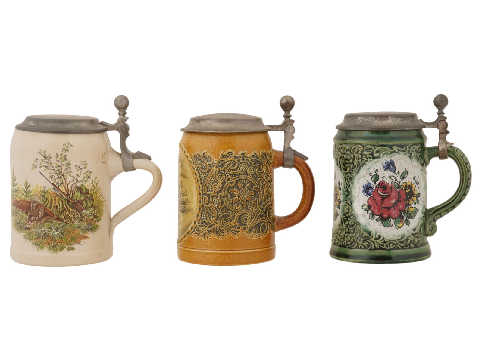 LOT OF MID CENTURY GERMAN STONEWARE BEER STEINS: A lot of three mid-20th century German stoneware beer steins. Handled cylinder vessels with hinged pewter lid. Beer stein with a transfer-printed hunting motif by Wick Werke, a manufacture active from