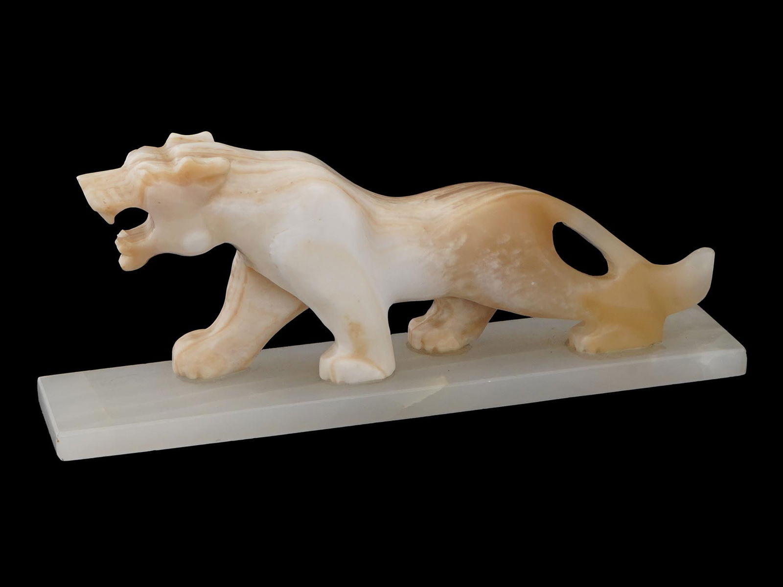 VINTAGE CARVED OPAL STONE FIGURINE OF A PANTHER: A vintage carved opal stone figurine of a panther, detailed and poised on a rectangular base. The figure is given a lifelike sense of movement and elegance. Vintage Carvings And Animal Figures For Col