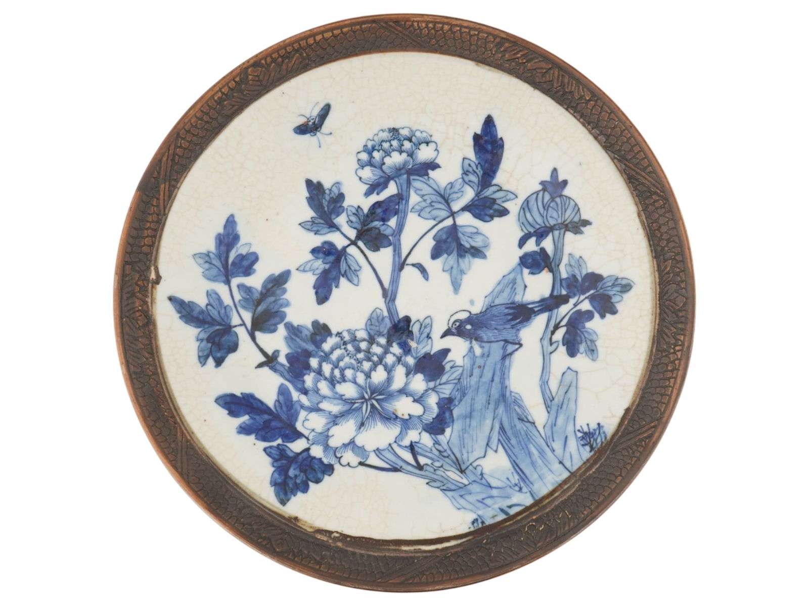ANTIQUE CHINESE CERAMIC BLUE AND WHITE PLATE.: An antique Chinese ceramic blue and white cabinet plate. Circa early 20th century. The plate features hand-painted cobalt blue peonies, birds, and insects. The rim features a mesh pattern with foliate