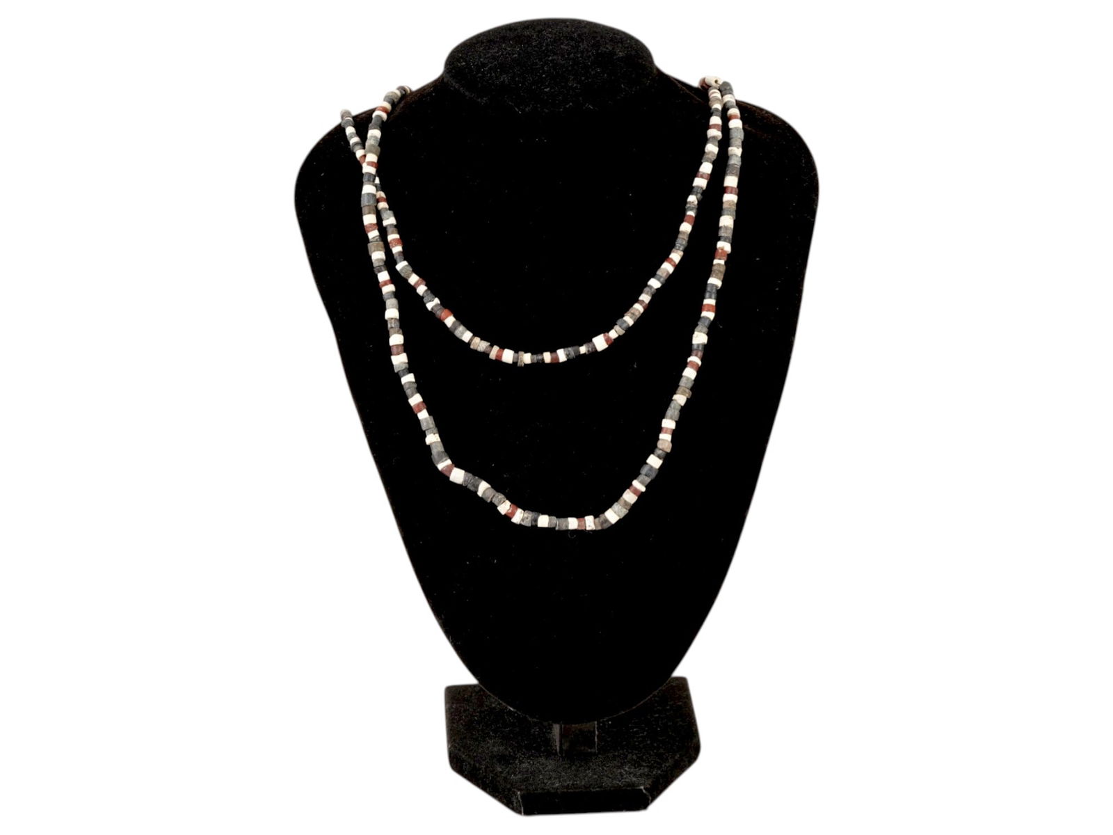 ANCIENT EGYPTIAN CARVED STEATITE STONE NECKLACES: A group of two ancient Egyptian carved steatite stone necklaces. CIrca Late Period, 700 to 200 BC. The necklaces are approximately the same length and consist of small tubular beads of alternating col