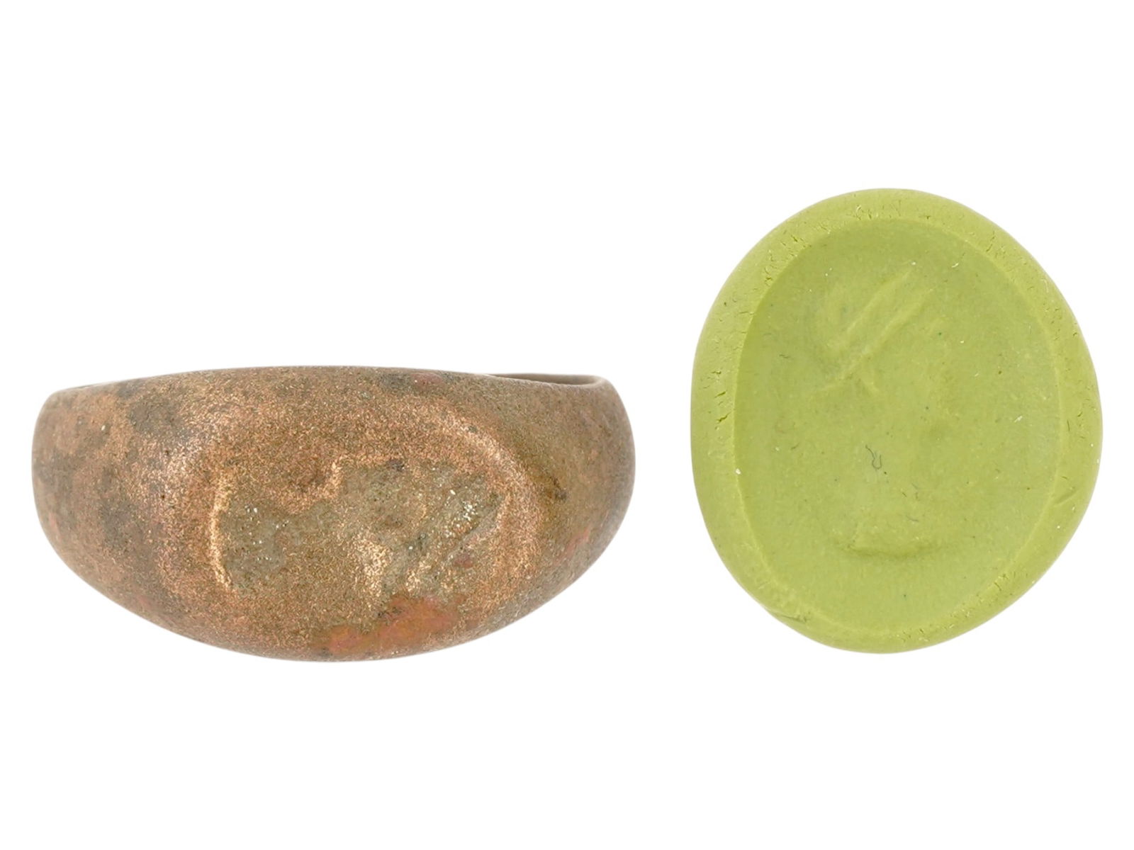 ANCIENT ROMAN ENGRAVED BRONZE SIGNET RING: An ancient Roman engraved bronze signet ring. The ring features a flat oval bezel with an engraved image representing a head of Aphrodite. Circa: 100 to 300 AD. Archaeological and Historical Wares, Br