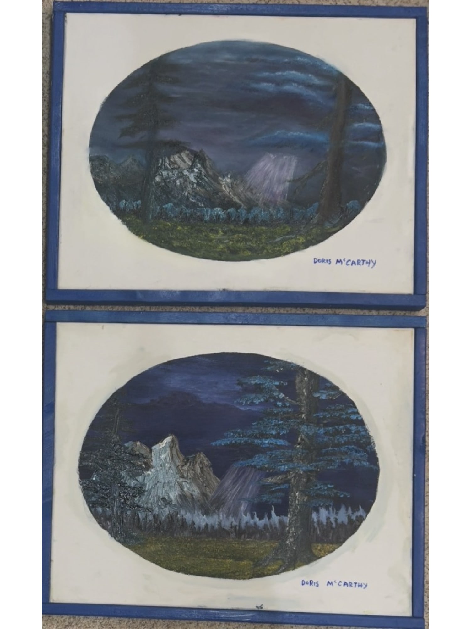 SIGNED DORIS MCCARTHY PAIR OF NOCTURNAL LANDSCAPES: This pair of oil on canvas paintings features two nocturnal mountain landscapes presented as oval vignettes within a rectangular field. Both works depict stylized, snow-capped peaks and pine forests u