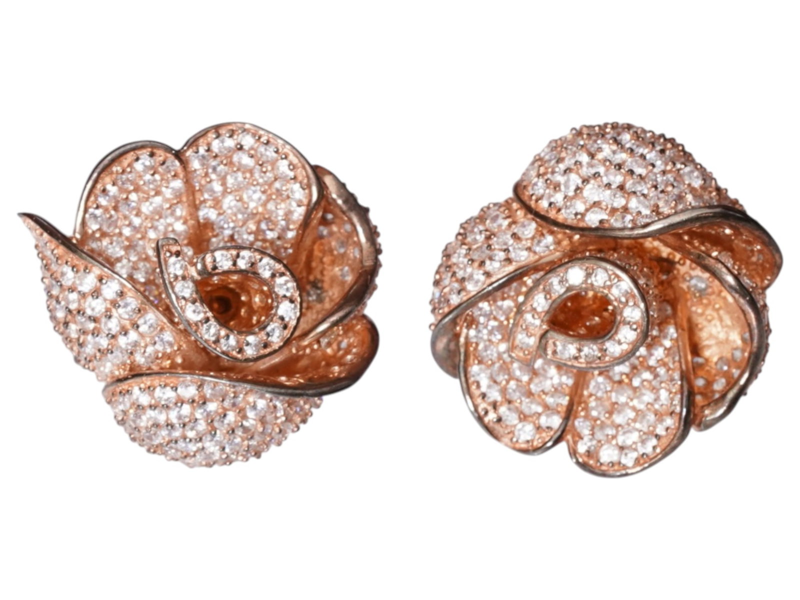 PAIR OF VINTAGE GILT STERLING EARRINGS W STONES: A pair of vintage earrings is executed in gilt sterling silver, featuring a sculptural rose motif with overlapping petals. Each flower head is embellished with a dense pave of round-cut champagne-hued