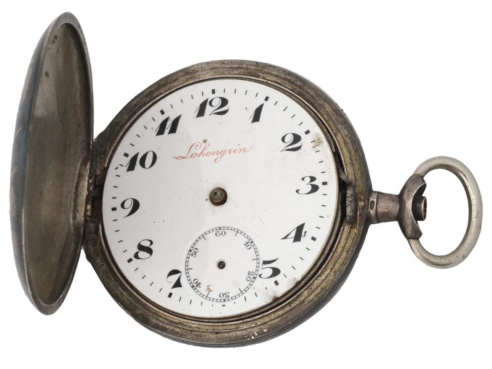 ANTIQUE 800 SILVER NIELLO LOHENGRIN POCKET WATCH: An antique 800 Continental Silver and niello Lohengrin pocket watch. A white enameled dial with black Arabic numerals. The watch has a double hunter case. The exterior of the case is adorned with an e