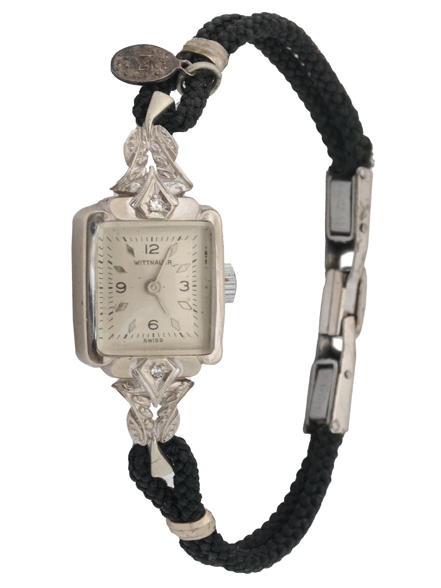 14K GOLD DIAMONDS WITTNAUER LADIES WRIST WATCH: A 14K White Gold Wittnauer ladies wrist watch. Swiss made. A white enameled dial with black and silver numerals and silver tone hands. The wrist watch is adorned with an engraved foliage pattern and