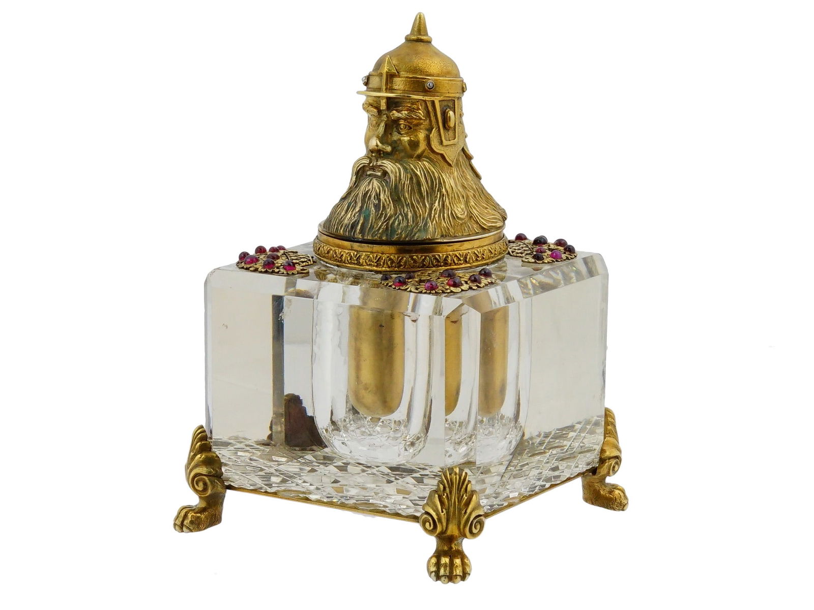 RUSSIAN GILT SILVER CUT CRYSTAL INKWELL W GARNETS: A Russian gilt silver cut crystal inkwell with garnet gemstones. The cut crystal inkwell raised on four legs in the shape of animal paws. The upper edge is decorated with applied baskets of flowers se