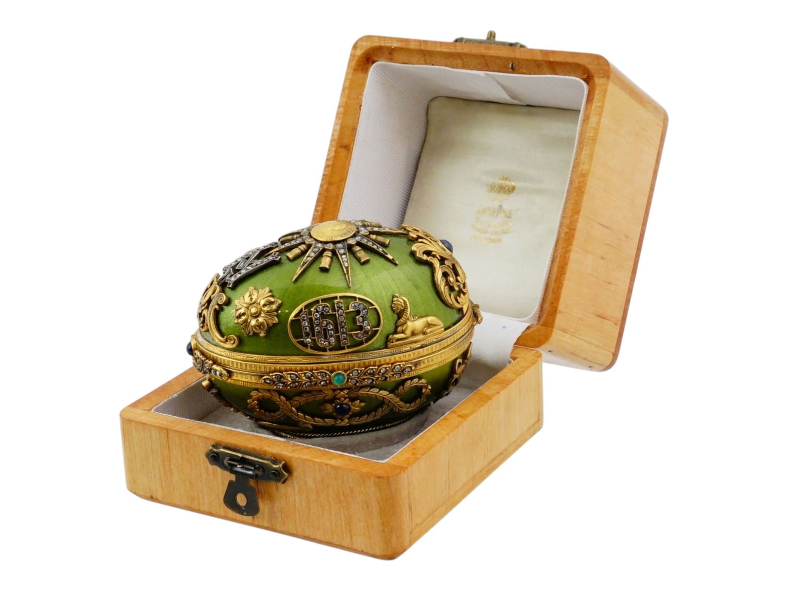 RUSSIAN EGG SHAPED SILVER ENAMEL BOX W MOUSE AND GEMS: A Russian egg shaped box features a vibrant green guilloche enamel body, accented by elaborate gilt silver filigree, floral and foliage motifs, small sphinxes and gemstones. On the top there is a coin