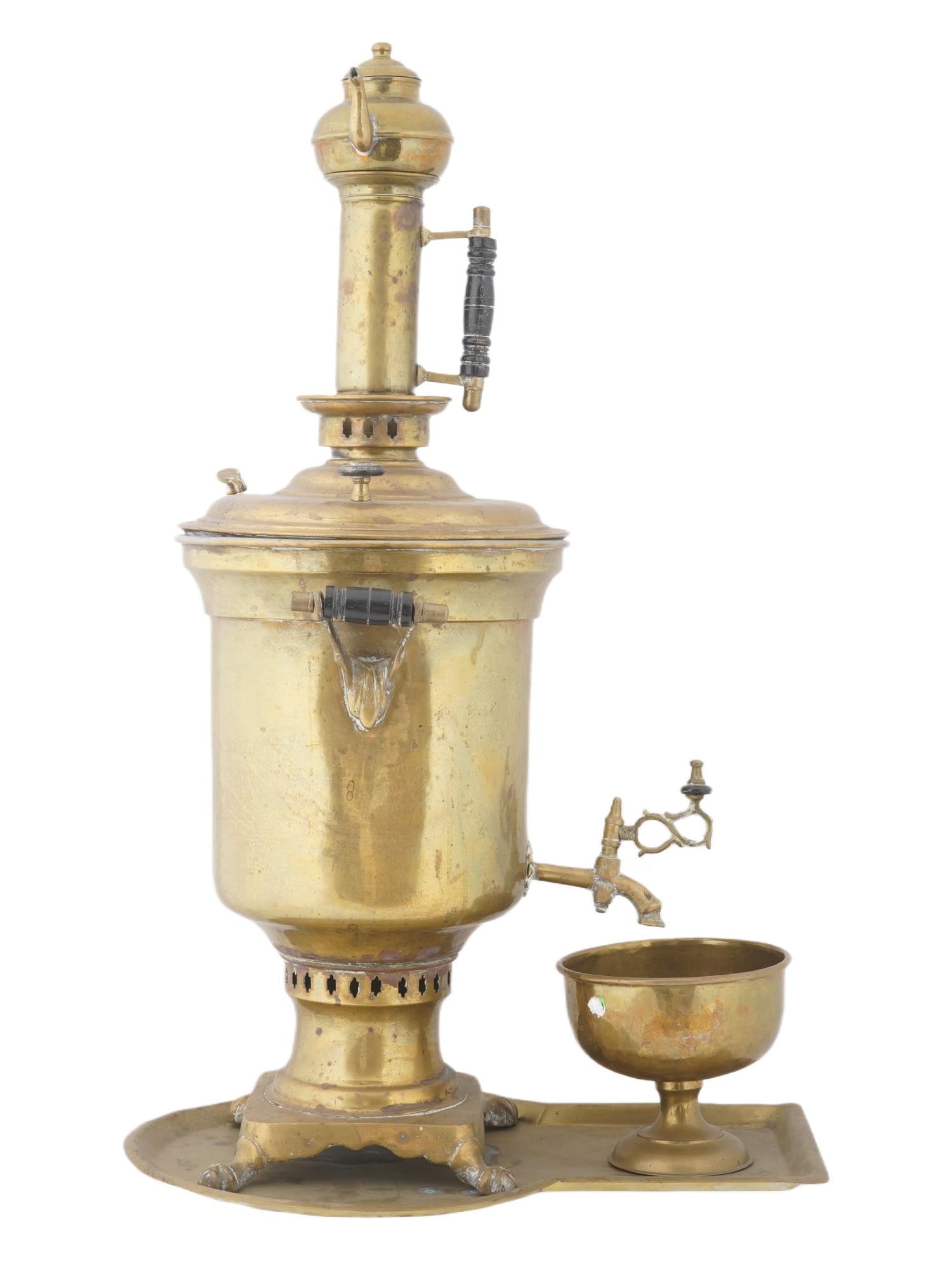 ANTIQUE RUSSIAN IMPERIAL BRASS SAMOVAR W STAND AND BOWL: An antique Russian Imperial brass samovar. The samovar has a slightly elongated cylindrical shape with two small handles on either side and one handle above. There is a kettle installed on top. The lo