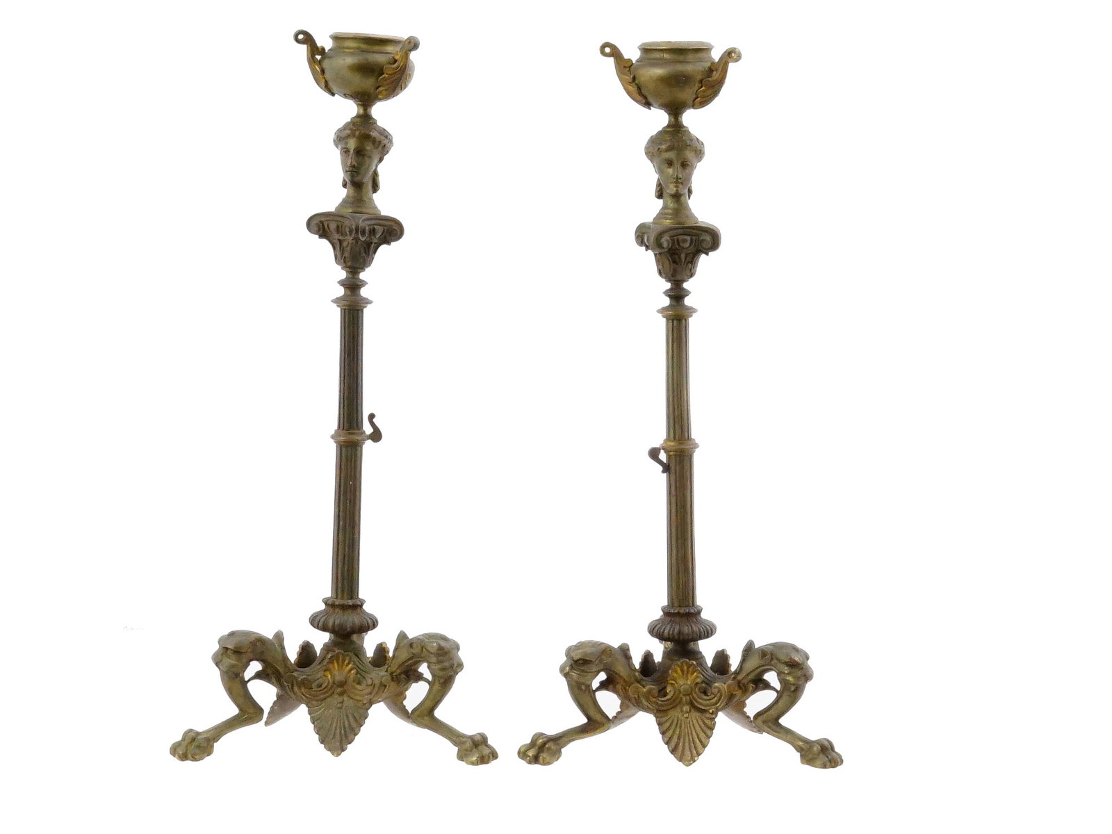 PAIR ANTIQUE EUROPEAN SCHOOL BRONZE CANDLESTICKS: A pair of antique European School bronze candlesticks. The candlesticks feature an unusual columnar design with finials featuring female heads holding vases. Each is complemented by three figural