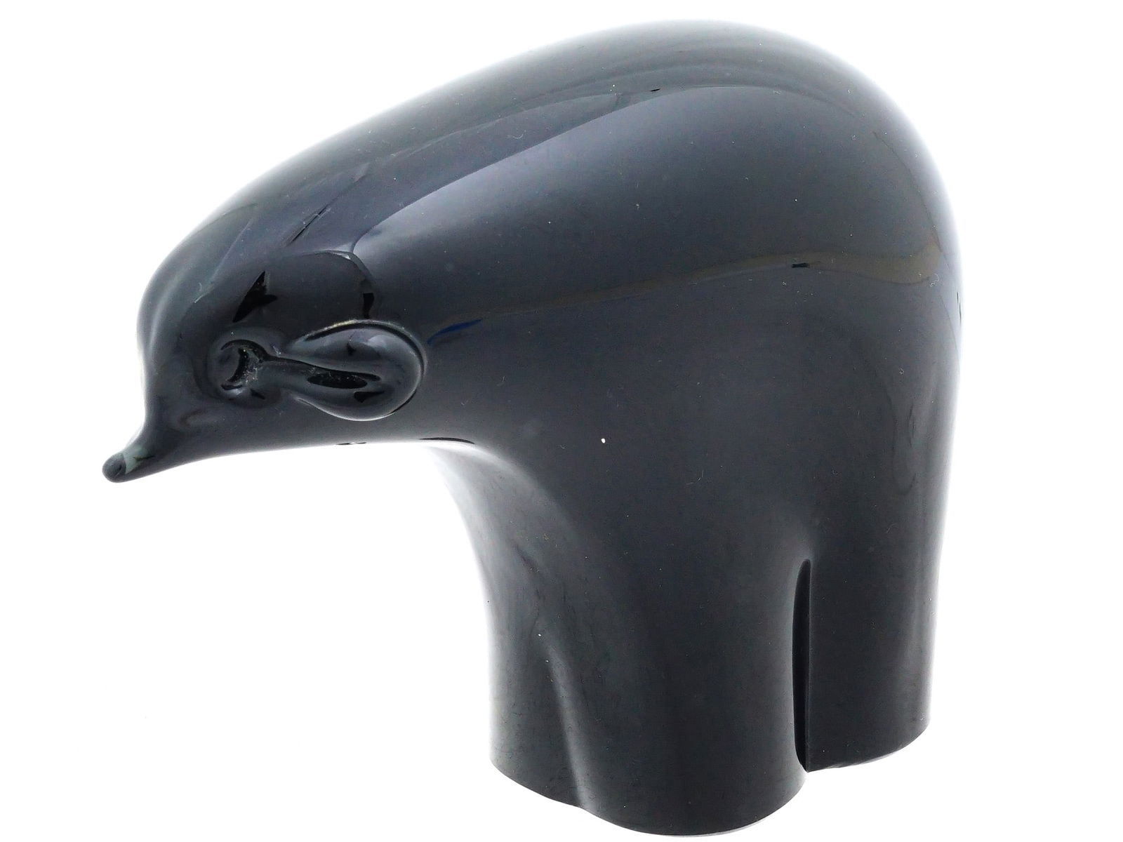 MINIMALIST BLACK GLASS SCULPTURE OF ELEPHANT: A minimalist sculpture depicts an elephant in a highly stylized, modern form, crafted from opaque black glass with a high-gloss finish. The figure features a smooth, rounded anatomy with a small trunk