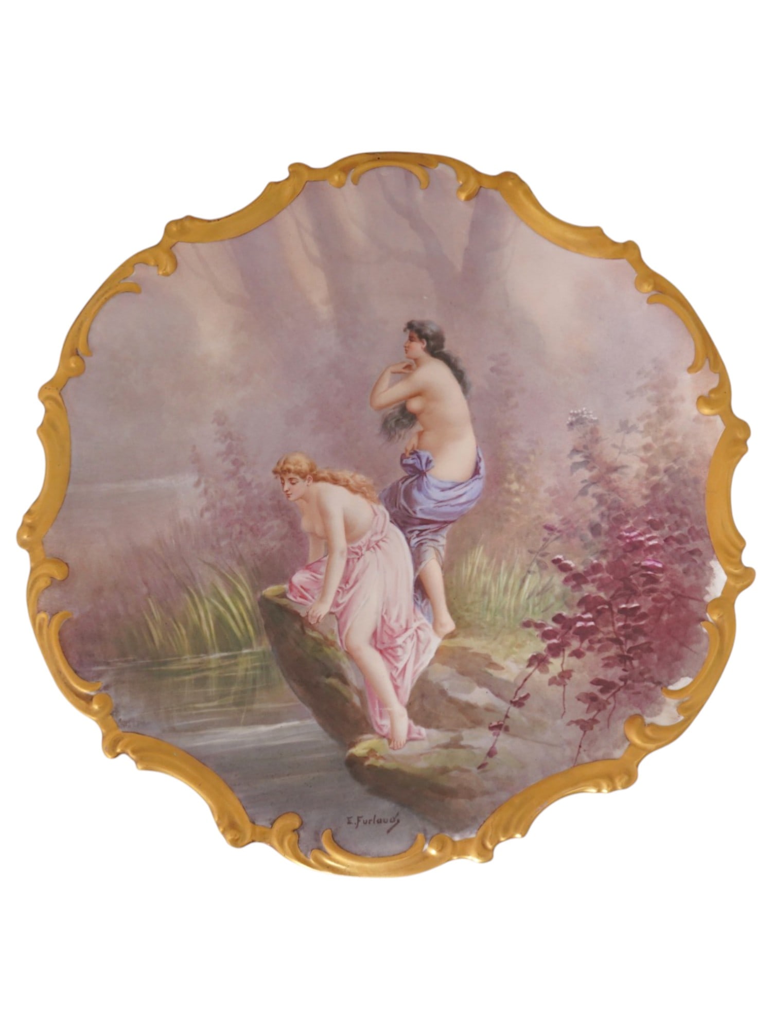 LARGE FRENCH LIMOGES PAINTED PORCELAIN CHARGER: A large French Limoges painted porcelain charger. The charger has an unusual shape with a wavy, raised edge trimmed in gold. In the center is an image of semi-nude girls by a pond against a natural la