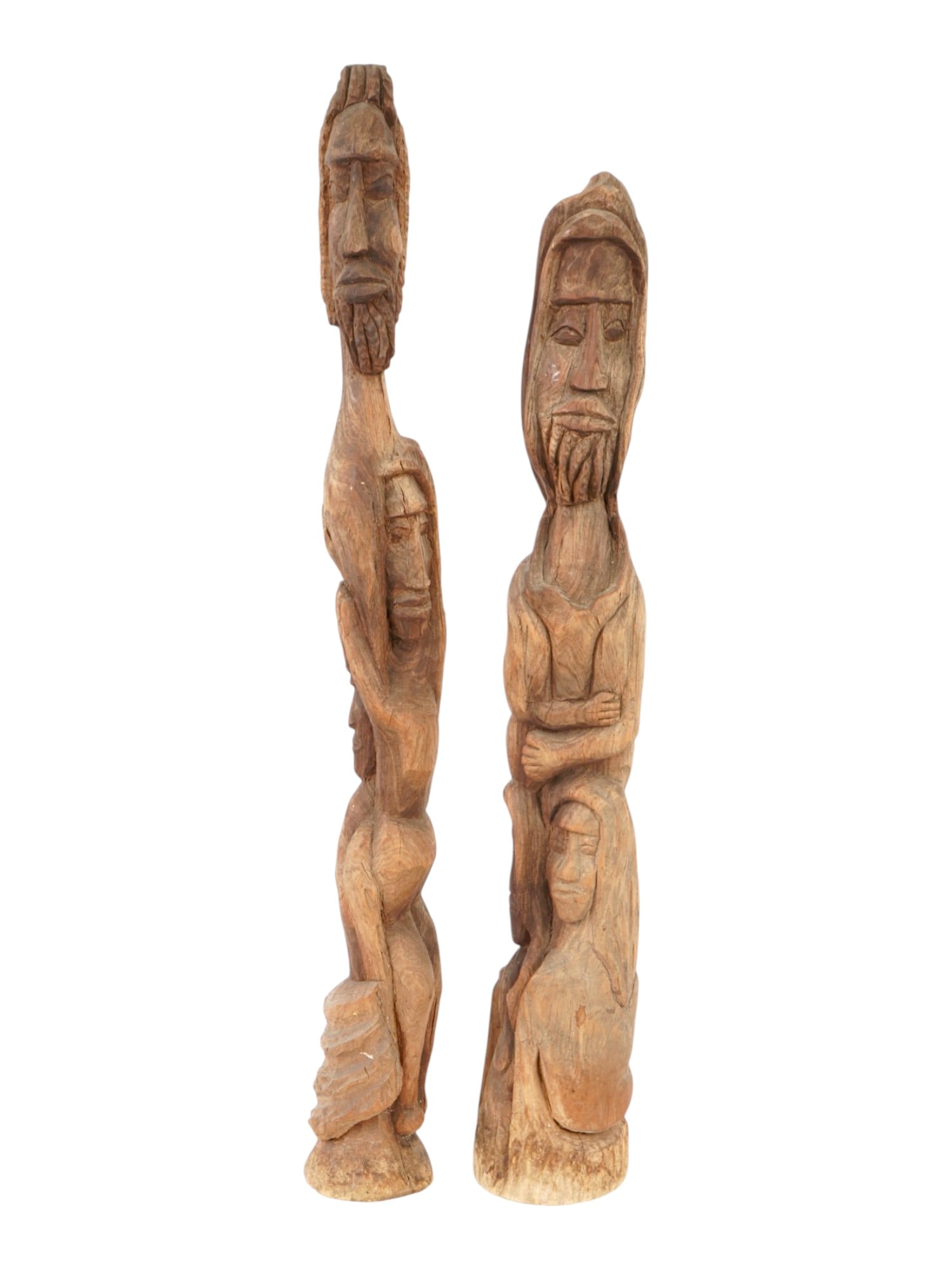 VINTAGE HAND CARVED WOODEN DEVOTIONAL FOLK FIGURINES: A pair of vintage hand-carved wooden devotional folk figurines depicting stylized human figures. The tall, elongated forms reflect traditional carving techniques associated with ancestral or spiritual