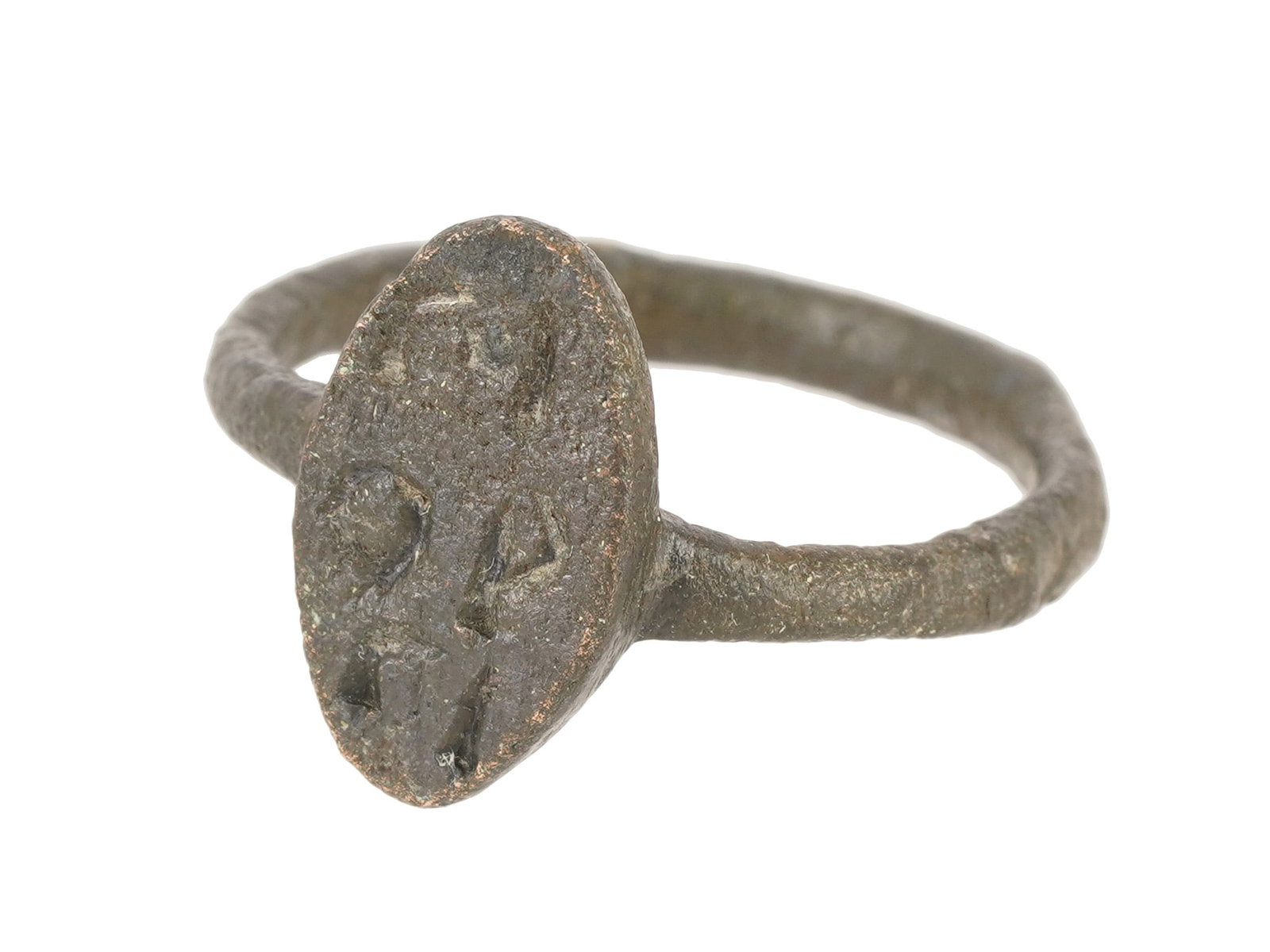 ANCIENT BYZANTINE BRONZE SIGNET RING 400 TO 600 AD: An ancient Byzantine bronze signet ring, dating from approximately 400 to 600 AD, features an oval bezel deeply incised with three horizontal rows of characters. The cast bronze construction includes
