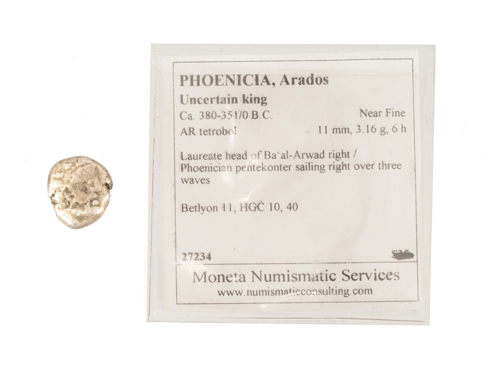 ANCIENT PHOENICIAN SILVER TETROBOL COIN 380 TO 351 BC: An ancient silver tetrobol coin from Phoenicia, Arados, dating to approximately 380 to 351 BC. The obverse depicts the head of Baal-Arvad, and the reverse depicts a Phoenician ship penteconter. The co