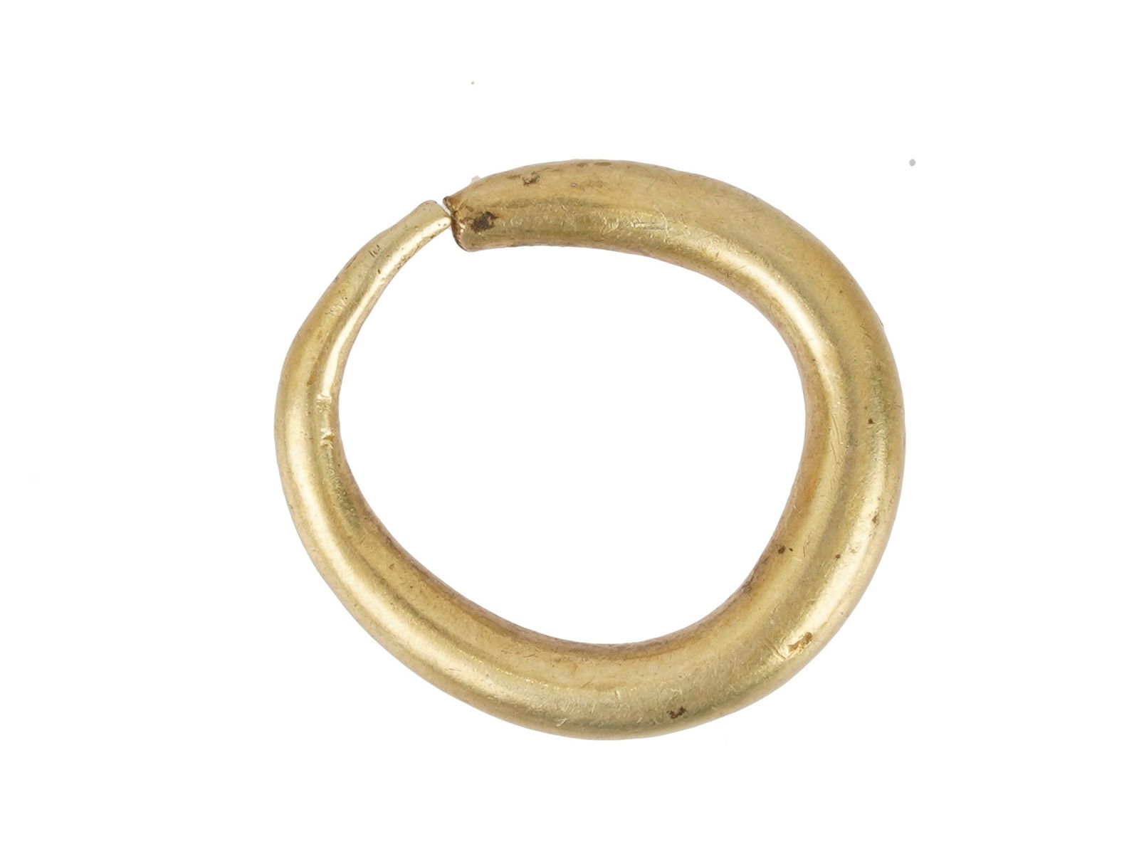ANCIENT ROMAN GOLD HOOP EARRING CA 100 TO 300 AD: An ancient Roman gold hoop earring, dating from 100 to 300 AD. The earring is round and tapered at one end. It could have been used as a nose piercing. Ancient Roman Gold Earrings and Jewelry Collecti