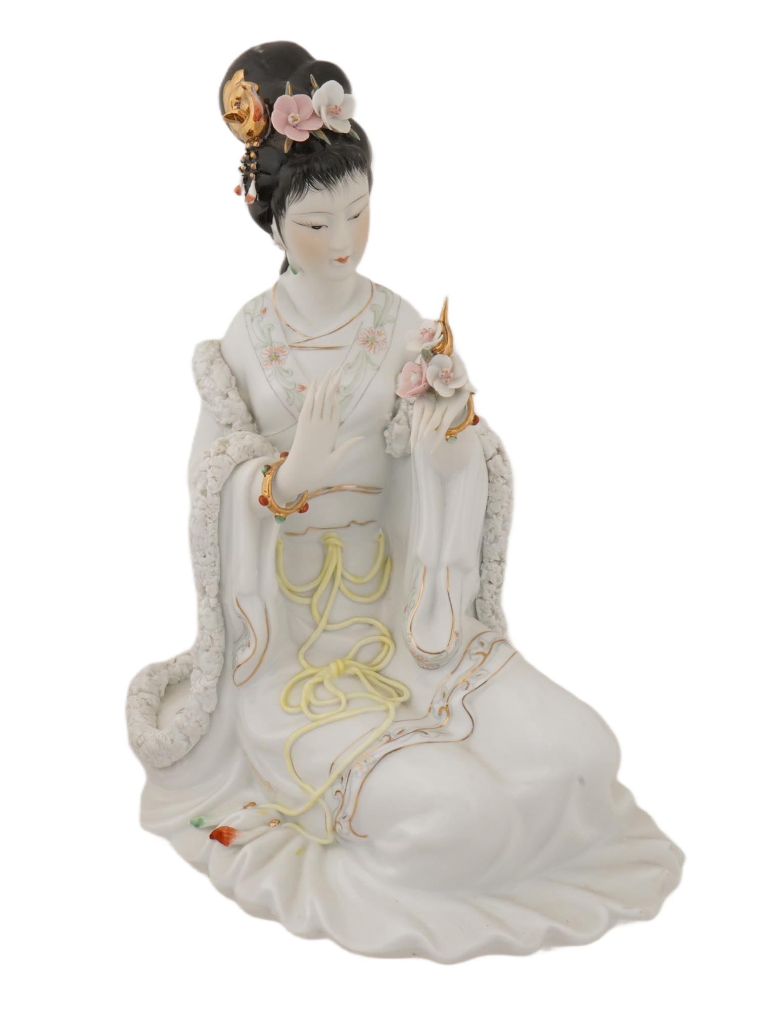CHINESE HAND PAINTED PORCELAIN FIGURINE OF LADY: A Chinese hand painted and gilded porcelain figurine depicts an Asian woman in traditional dress holding a flower. Similar pieces are often referred to as Oriental beauties or geishas. Executed in a t