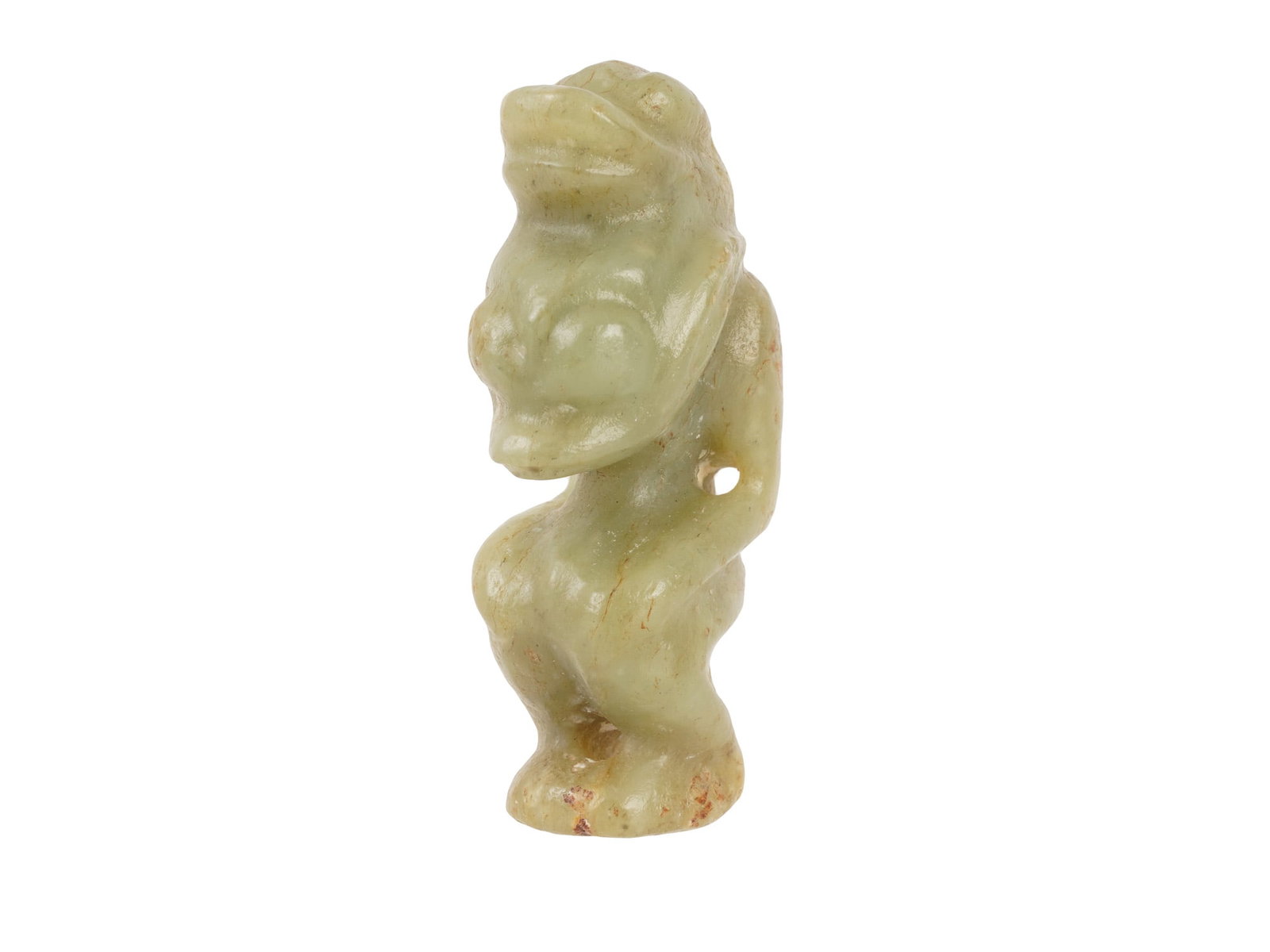 CHINESE CARVED CELADON JADE ANIMAL FIGURINE AMULET: A Chinese carved Jade figurine. The figurine is carved from a pale celadon stone with areas of russet skin, depicting a seated mythological creature or probably a monkey in a crouching posture. The fi