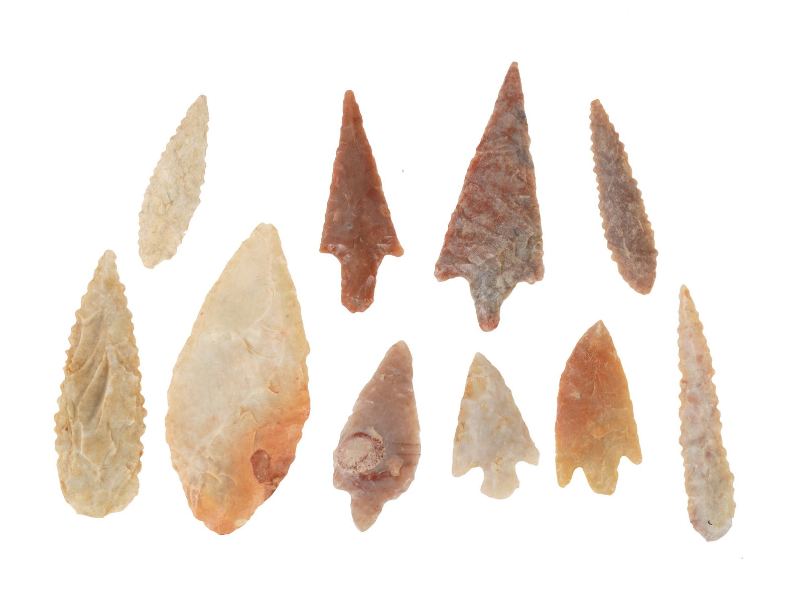 COLLECTION OF HAND CARVED STONE POINTS ARROW HEADS: A collection of ten hand carved stone points that were used by ancient people as arrowheads, darts or spearheads. The pieces are made from flint and other hard stones such as agate using the technique