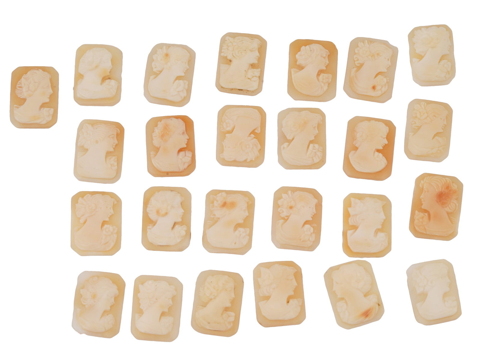 COLLECTION OF FEMALE PORTRAIT CARVED SHELL CAMEOS: A collection of hand carved shell cameos. A total of 25 items. Each piece depicts a female profile portrait rendered in high relief in the Victorian manner. Each cameo is fashioned in a distinctive oc