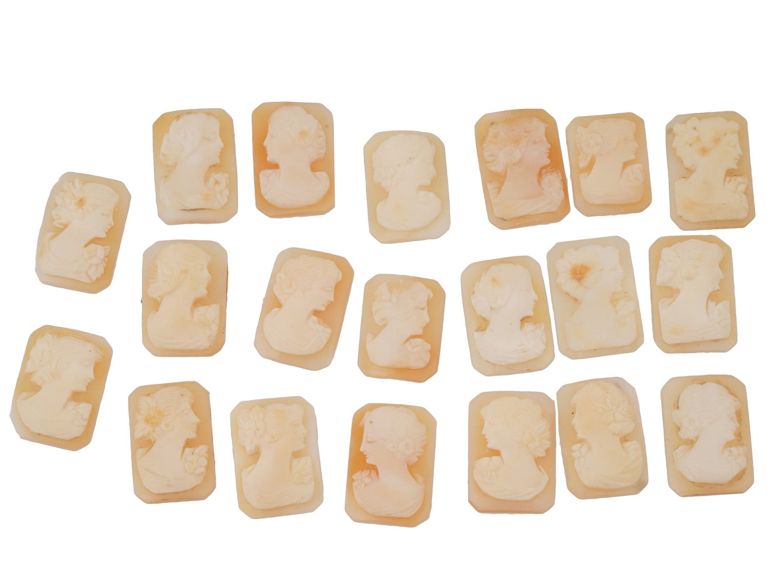 COLLECTION OF CARVED FEMALE PORTRAIT SHELL CAMEOS: A collection of hand carved shell cameos. Each piece depicts a female profile portrait rendered in high relief in the Victorian manner. Each cameo is fashioned in a distinctive octagonal medallion for