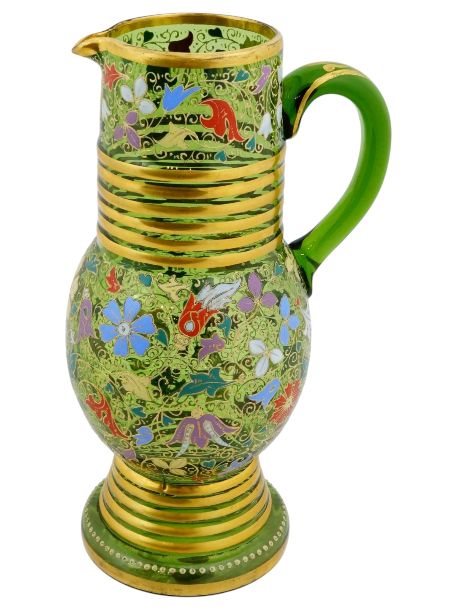 ANTIQUE BOHEMIAN MOSER GREEN GLASS PITCHER: An antique Bohemian Moser pitcher crafted from hand-blown Forest Green glass. The surface is decorated with floral motifs and accented with jeweled enamel work and banded gilding at the neck and base.