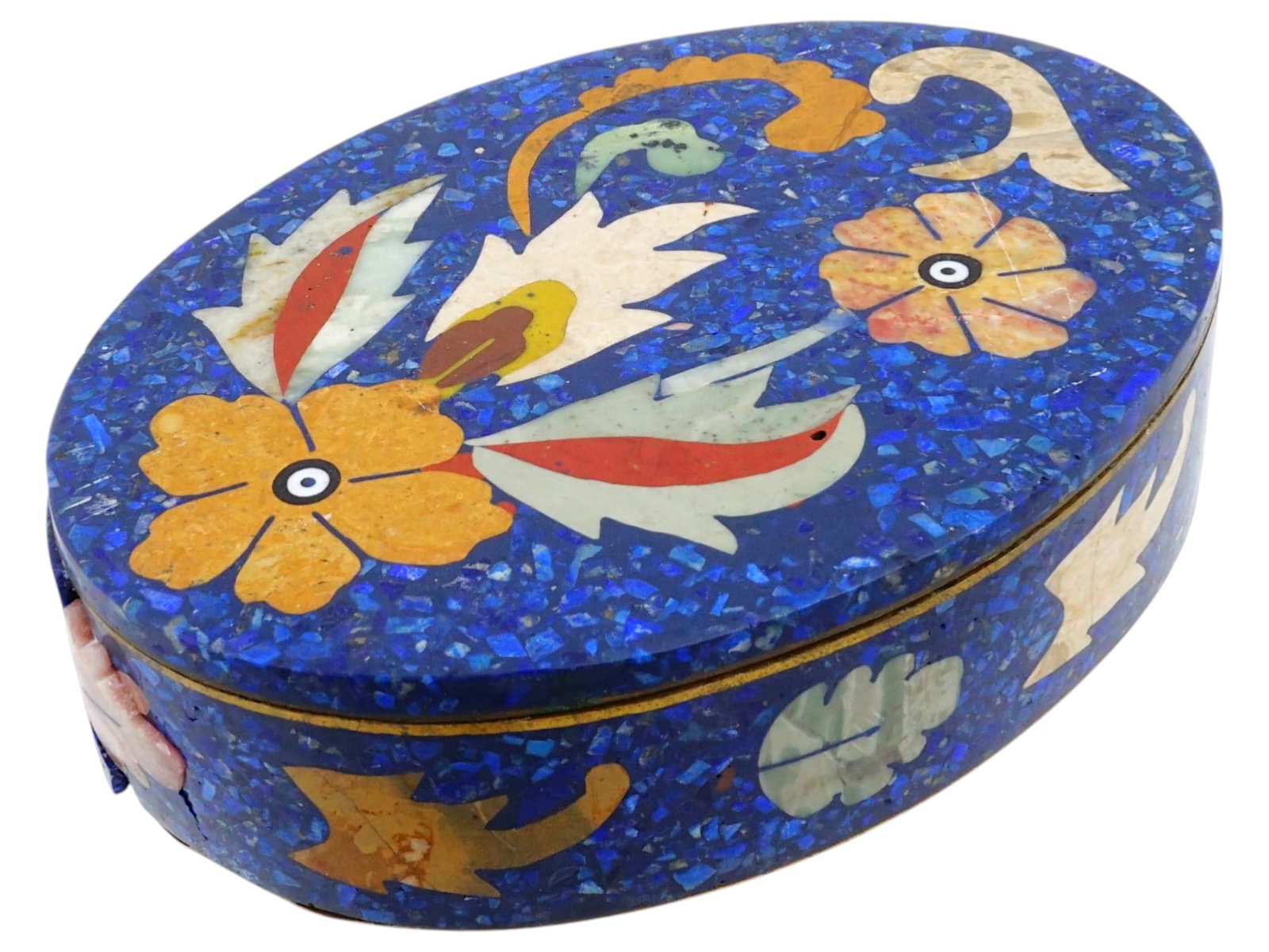 OVAL PIETRA DURA LAPIS LAZULI AND BRASS FOOTED BOX: An oval shaped brass trinket box made in the pietra dura technique. The box features a lapis lazuli mosaic ground, intricately inlaid with various semi precious stones in a traditional floral and foli