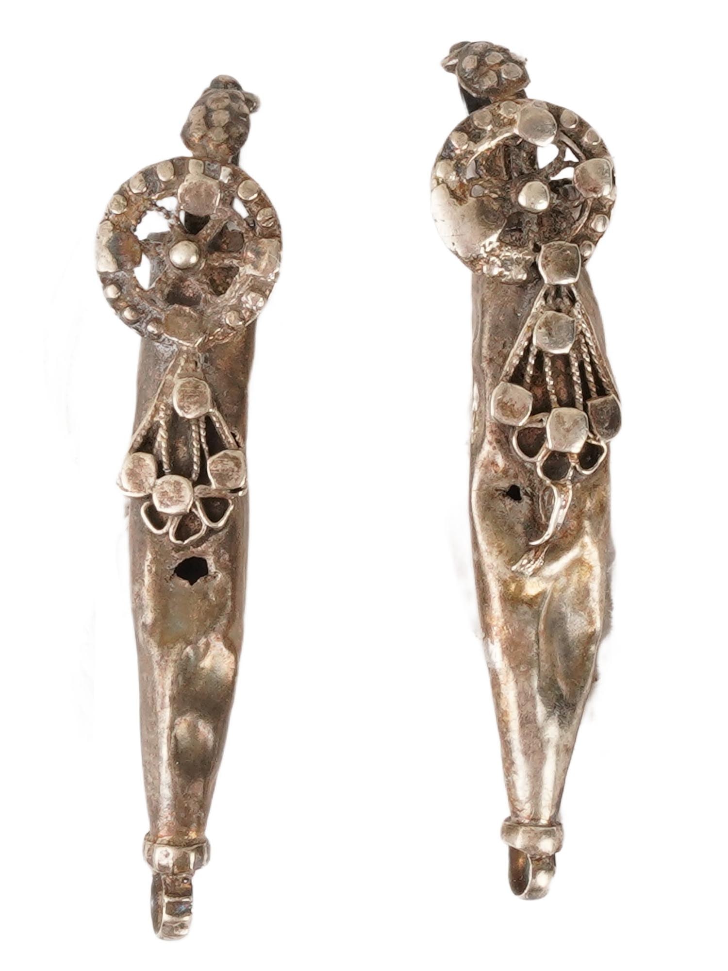PAIR OF ANCIENT BYZANTINE SILVER EARRINGS OR PENDANTS: A pair of large ancient Byzantine silver earrings or pendants, dating to circa 350 to 550 AD, each adorned with a circled cross motif with a dotted pattern. Exemplify early Christian symbolism and the
