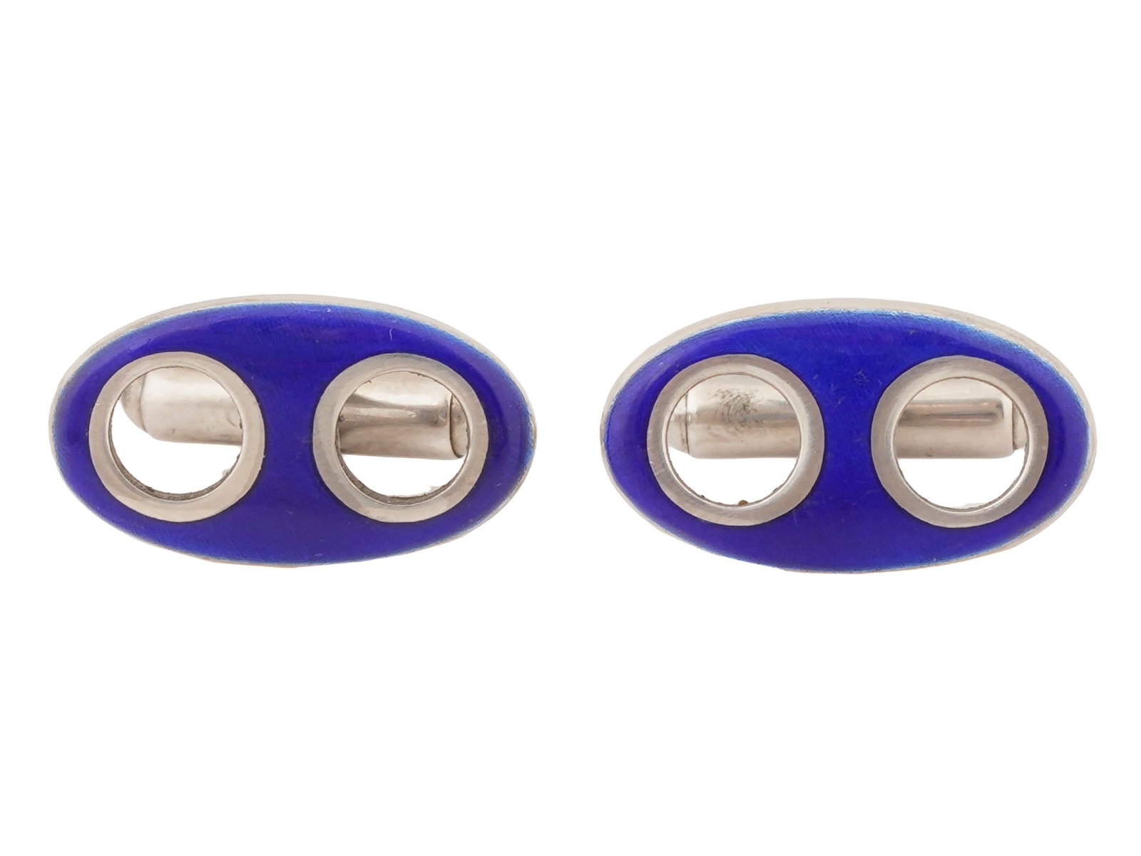VTG ITALIAN STERLING SILVER AND BLUE ENAMEL CUFFLINKS: A pair of vintage Italian sterling silver and blue enamel double oval cufflinks. Marked Italy on the back side. The items feature an oval face with a vibrant, cobalt blue enamel border encircling a si