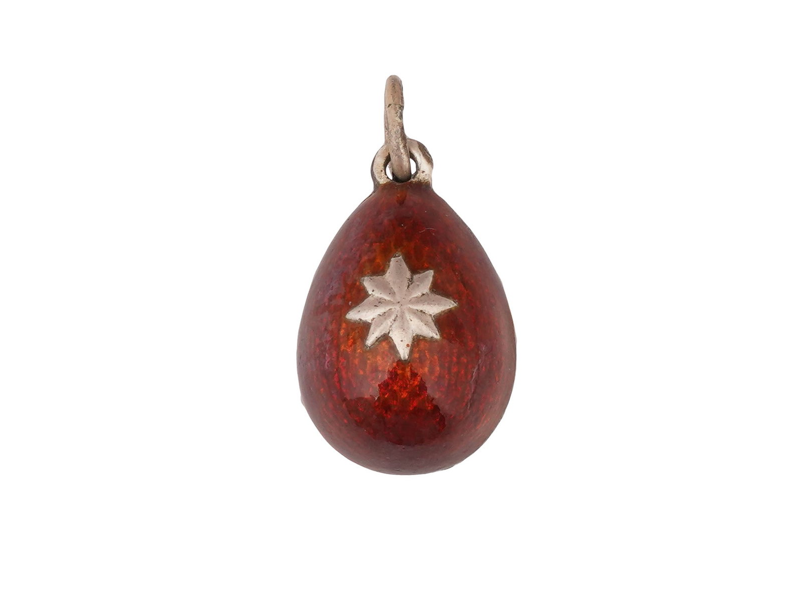 RUSSIAN SILVER GUILLOCHE ENAMEL EASTER EGG PENDANT: A Russian 88 gilt Silver and enamel Easter egg pendant. The exterior of the egg is covered with Guilloche enamel in a red shade and adorned with a relief design representing a star. Marked with a Russ