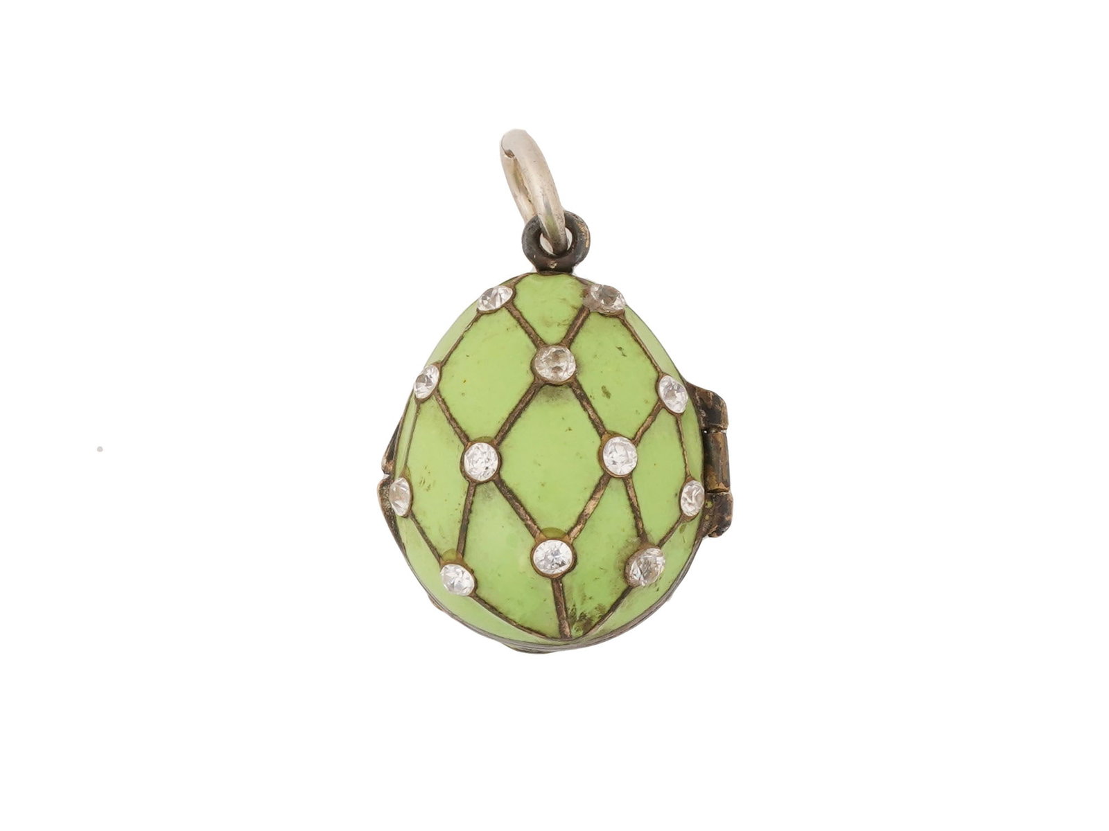 RUSSIAN SILVER ENAMEL EGG LOCKET PENDANT W GEMSTONES: A Russian gilt silver Easter egg locket pendant made of two fastened halves with a space for storage of memorabilia. The exterior of the egg is covered with olive green enamel over a guilloche ground.