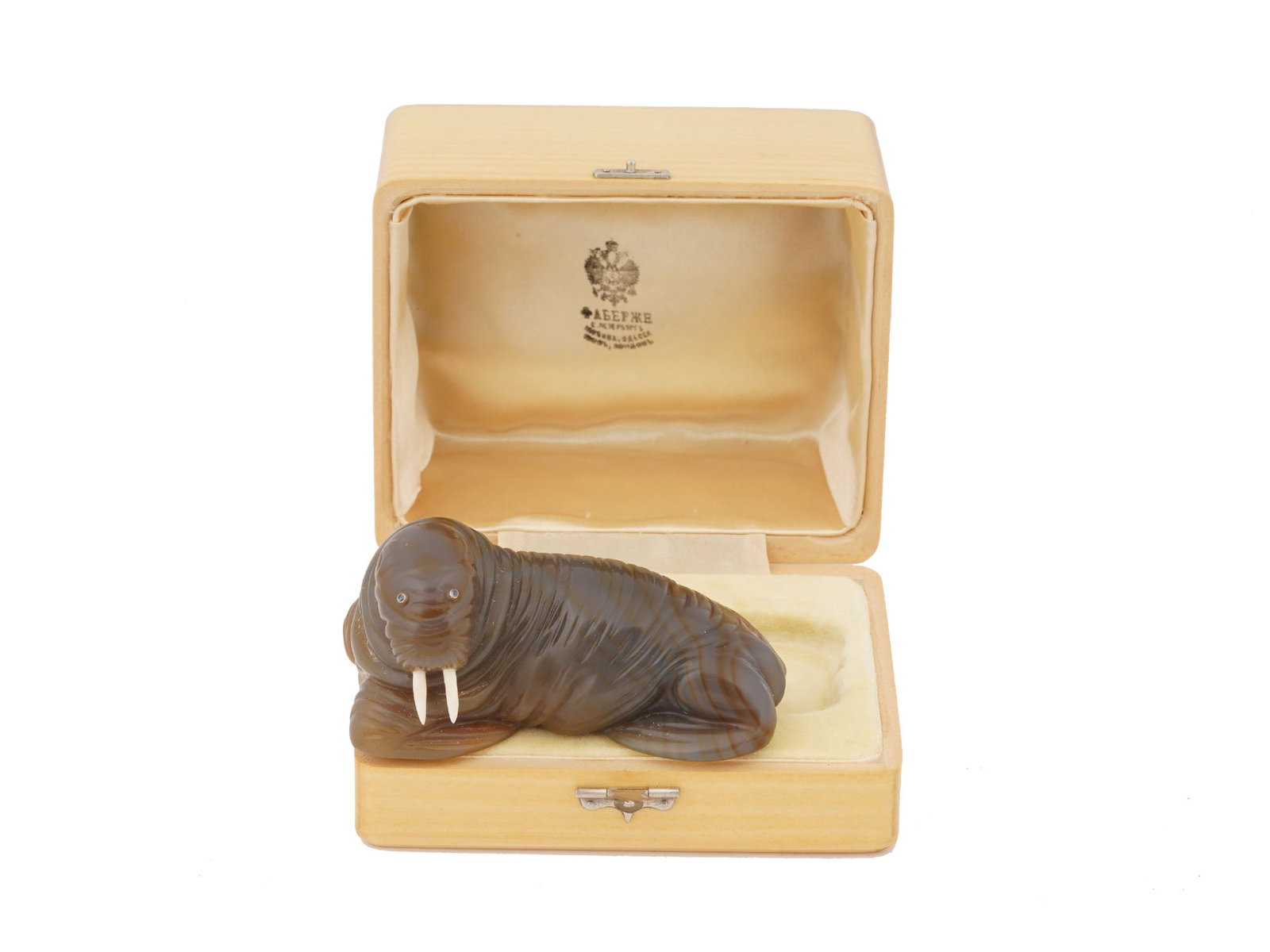 RUSSIAN CARVED AGATE GOLD SAPPHIRES WALRUS FIGURINE: A Russian carved agate figurine naturalistically hand carved in the shape of a resting walrus. The eyes are set with cabochon cut sapphires in golden frames. The tusks are made of natural materials. C