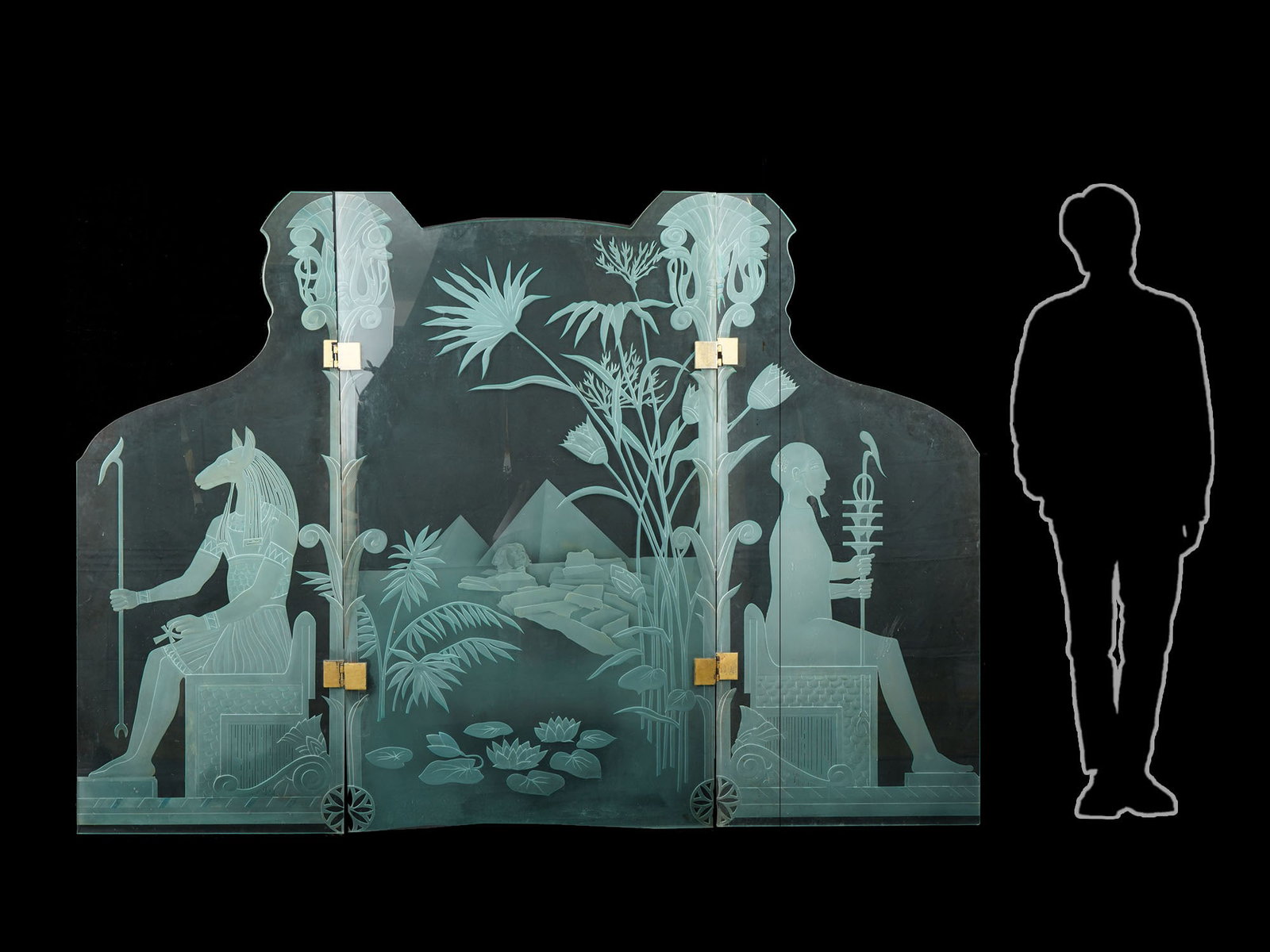 EGYPTIAN STYLE THREE PANEL ETCHED GLASS FLOOR SCREEN: A contemporary three-panel floor screen is a notable example of modern Egyptian Revival decorative art. The piece is characterized by its heavy glass construction and detailed etched imagery that pays