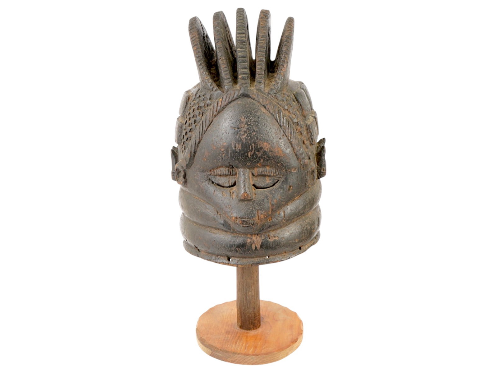 19TH C WEST AFRICAN MENDE CARVED WOOD HELMET MASK: A 19th century West African Guinea ritual helmet mask, also known as the Bundu mask, originates from the Mende culture. This is one of the few types of African masks worn exclusively by women. The mas