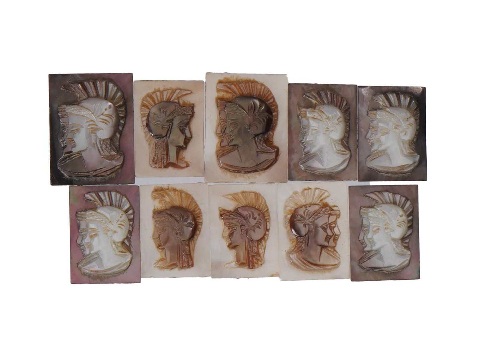 ANTIQUE VINTAGE GRECO ROMAN PROFILE CARVED SHELL CAMEOS: A collection of ten antique or vintage hand carved shell cameos, each depicting the head profile of a Greco-Roman figure wearing a crested helmet. Carved from a mother of pearl or abalone shell, the p