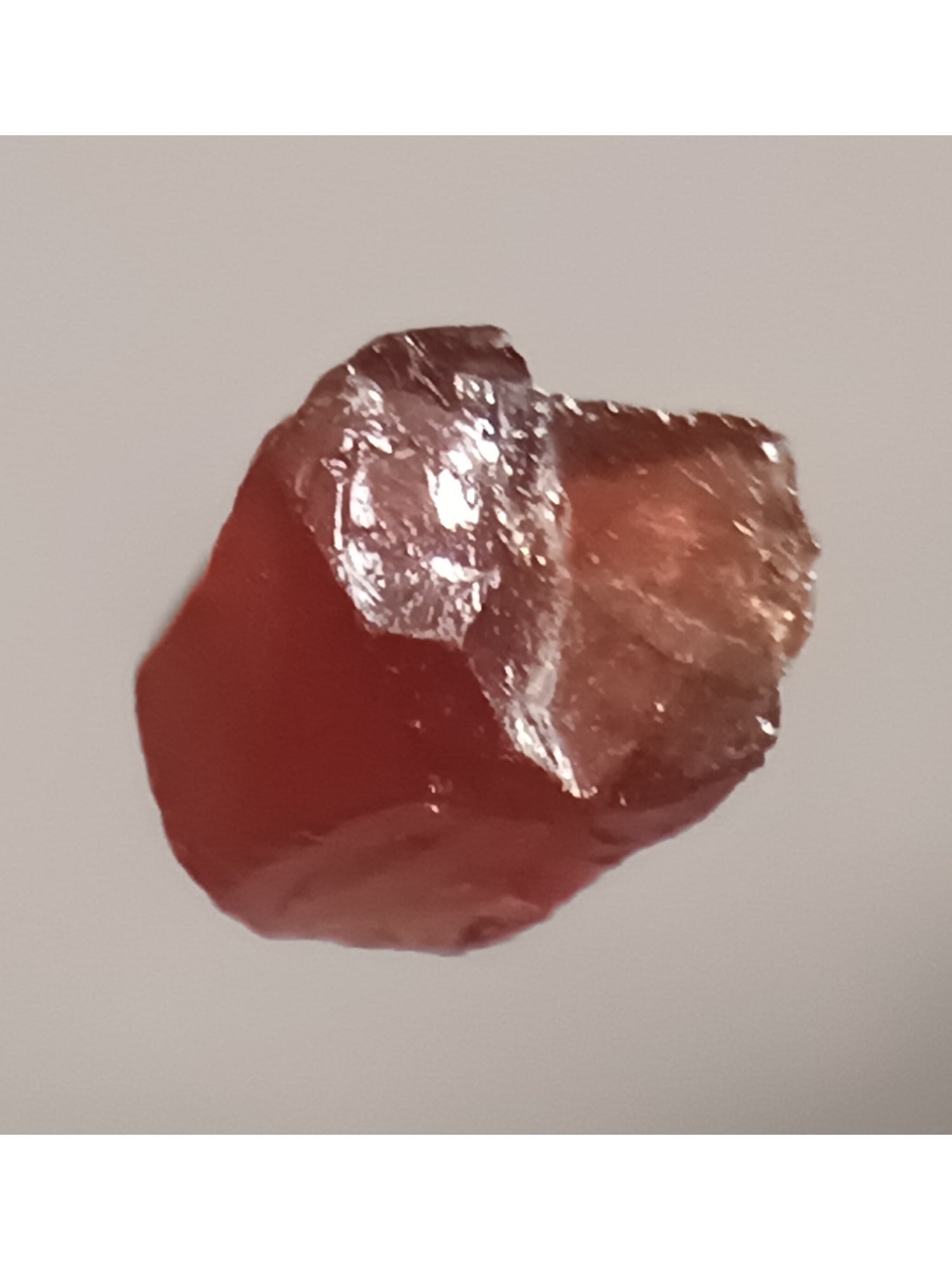 DARK ORANGE RED RHODOLITE: Dar orange red rhodolite (rho1/20). Weight: 0.18 grams / 0.7 ct. Origin: Cuamba, Niassa Prov. Mozambique. THIS LOT QUALIFIES FOR A 30-DAY UNCONDITIONAL RETURN FROM THE DATE OF SALE. BUYERS ARE