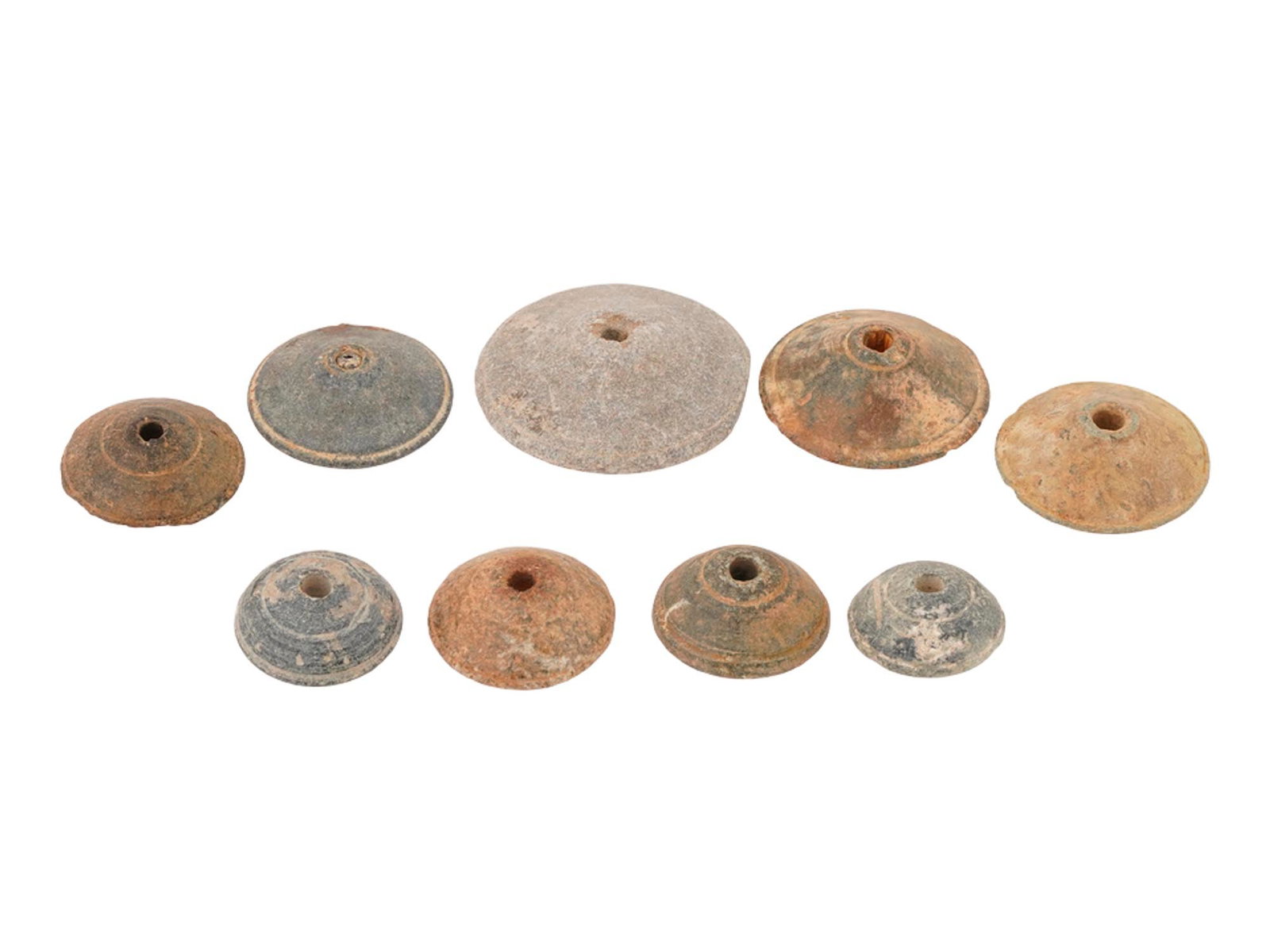 ANCIENT EGYPTIAN STEATITE SPINDLE WHORLS 700 TO 200 BC: A collection of nine ancient Egyptian Late Period carved Steatite spindle whorls. The wares are presented in various sizes. Circa 700 to 200 BC. Their detailed engravings highlight both artistic preci