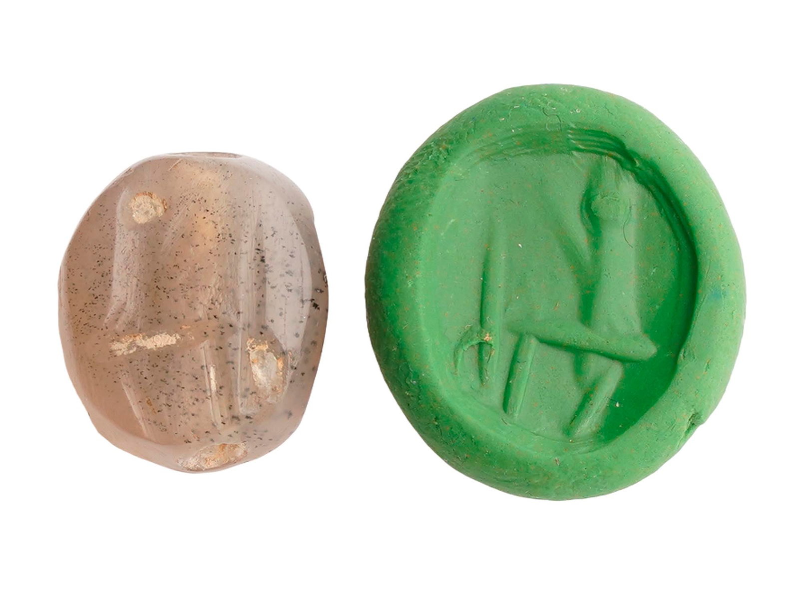 ANCIENT NEAR EASTERN ENGRAVED SCARAB AGATE SEAL: An ancient Near Eastern seal, dating to the 2nd Millennium BC, is carved from a piece of translucent banded agate exhibiting natural white and tan stratification. The scaraboid form features a flat fa